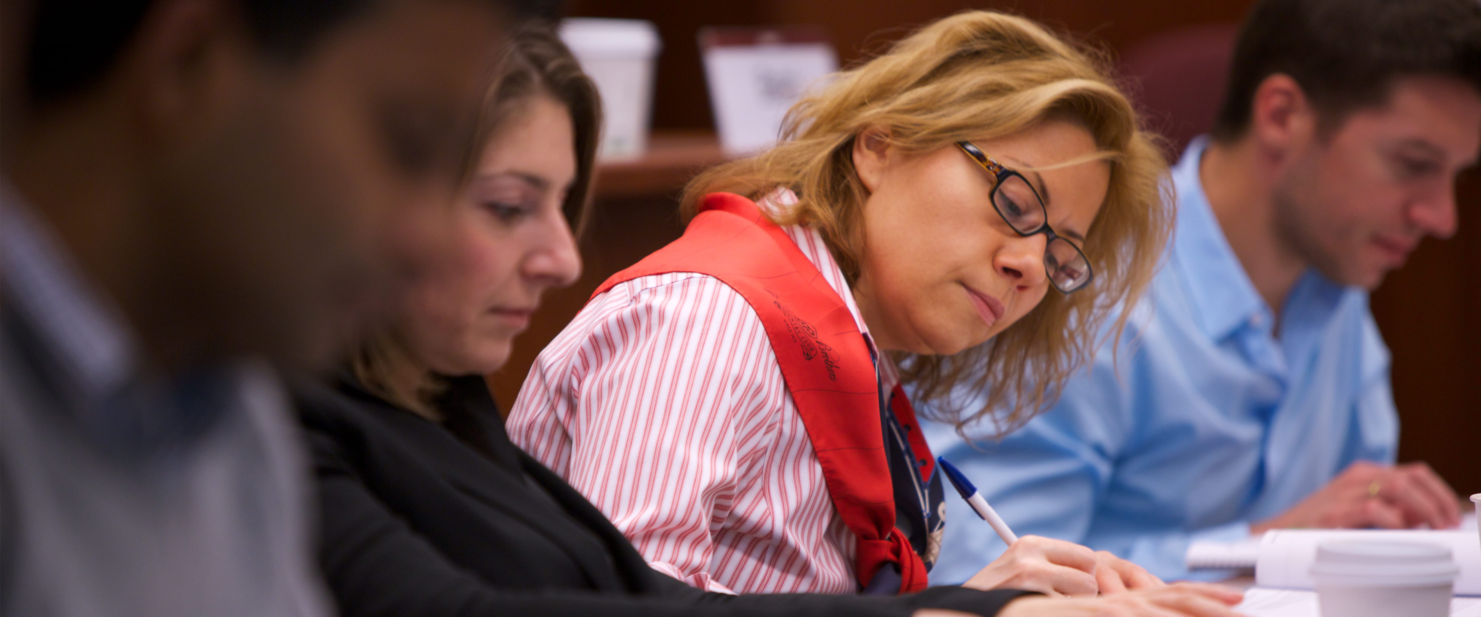 female student taking notes in class