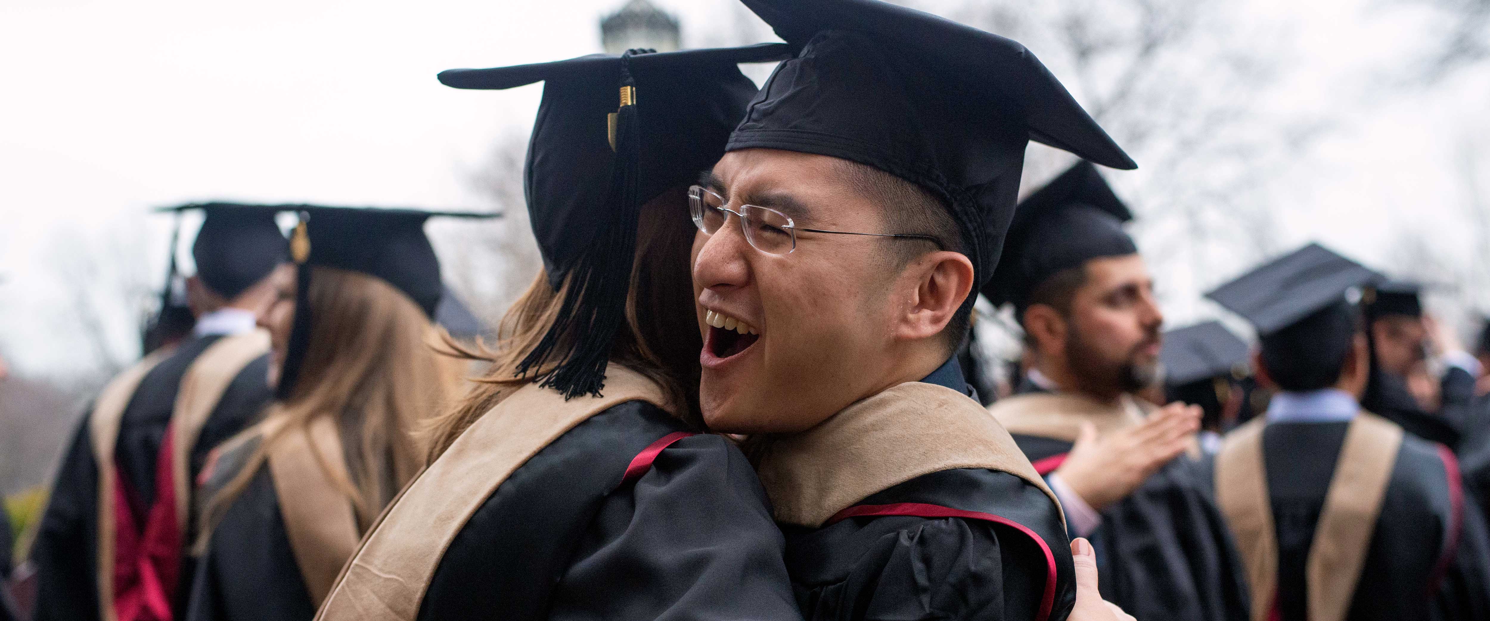 Chicago Booth students hugging at graduation