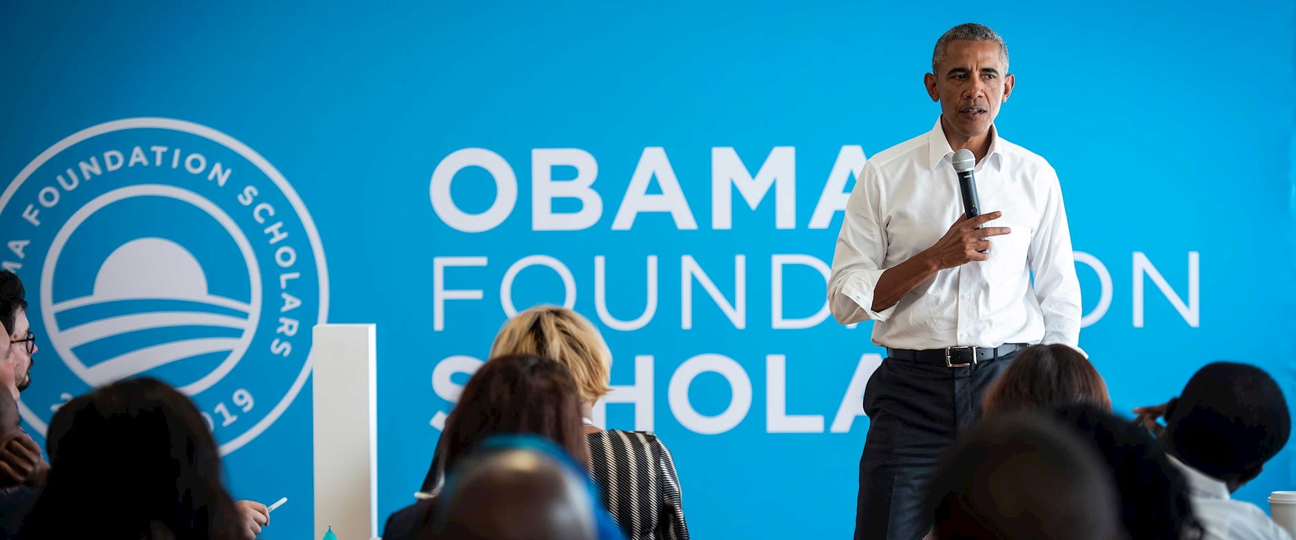 Barack Obama sspeaking in front of a foundation sign