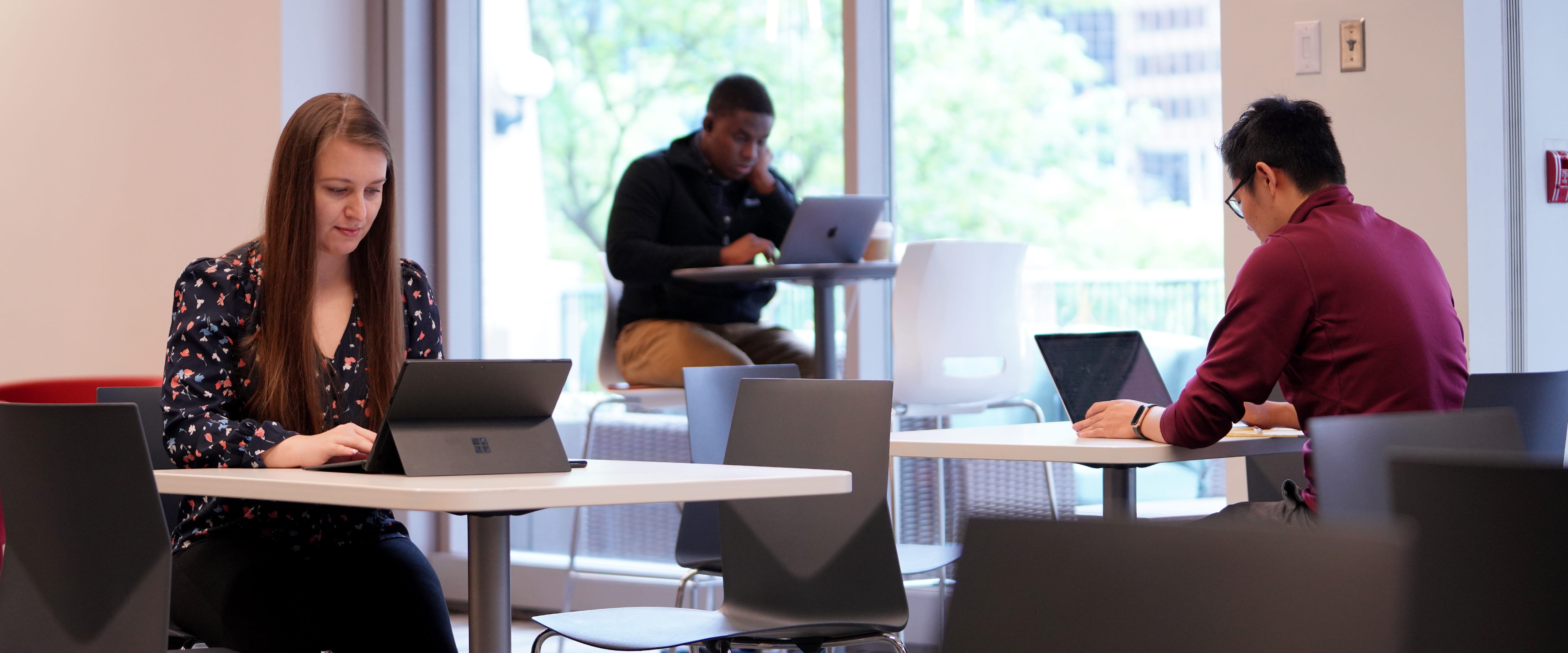 Woman at laptop wearing earbuds