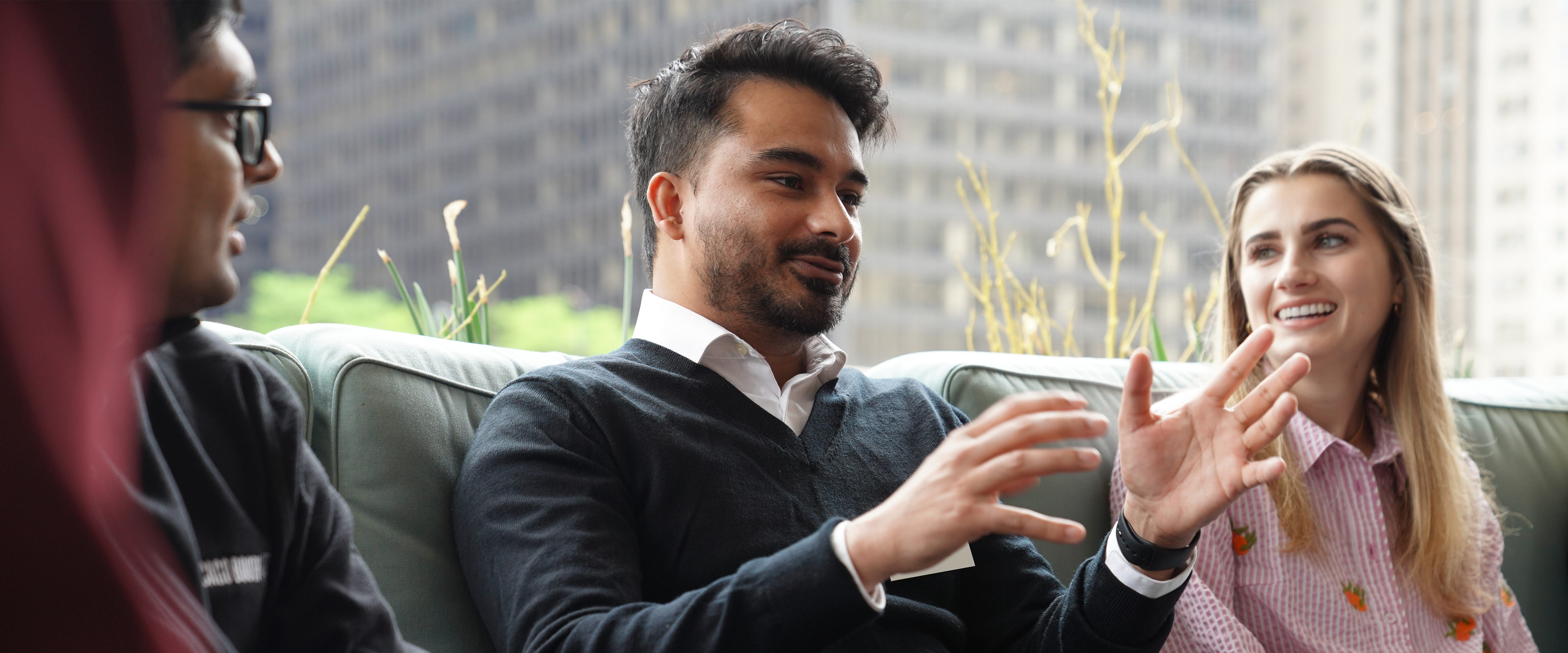 Man speaking to others and using his hands. 