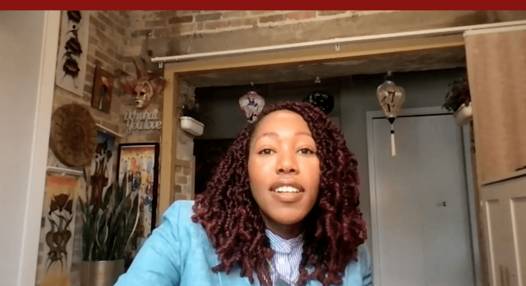 A Booth student looks into the camera during a zoom interview. 