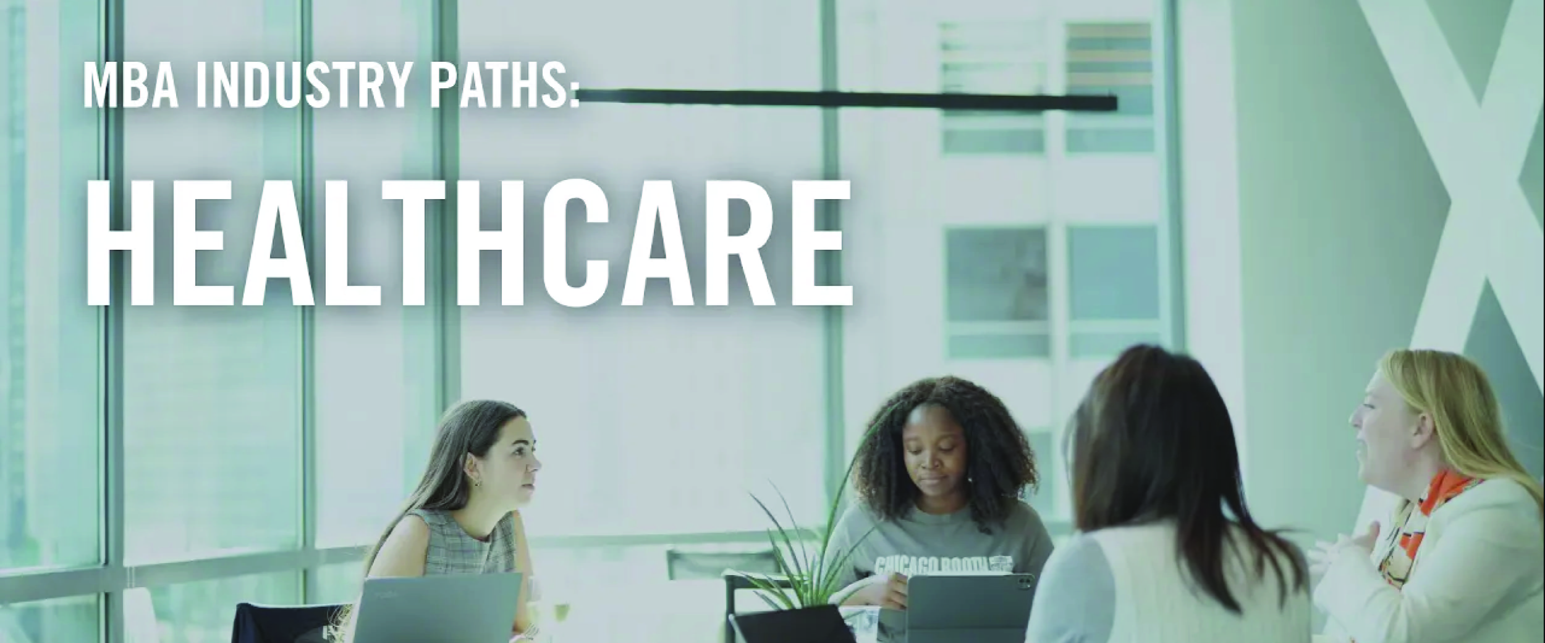 Several Booth students sit around a table studying at the Gleacher Center
