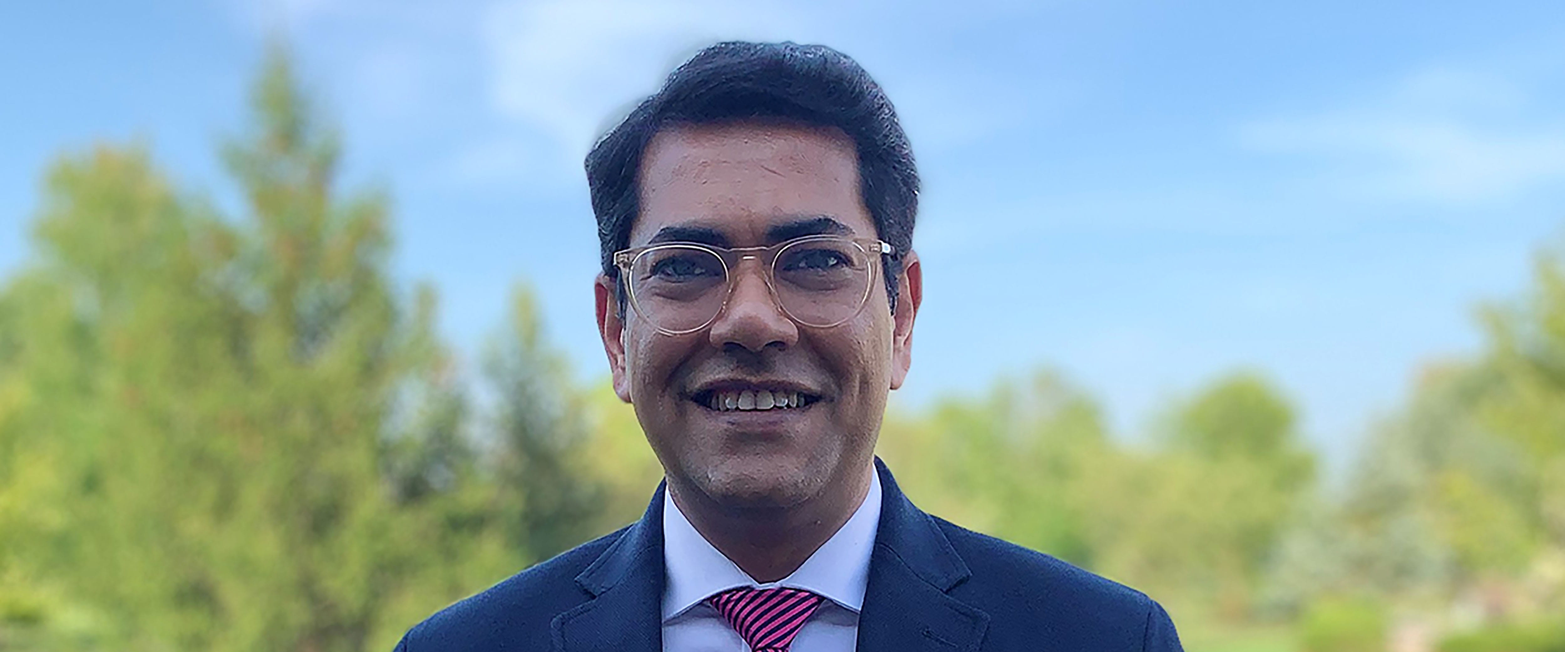 Chicago Booth Executive MBA student Atri Sen smiles at camera