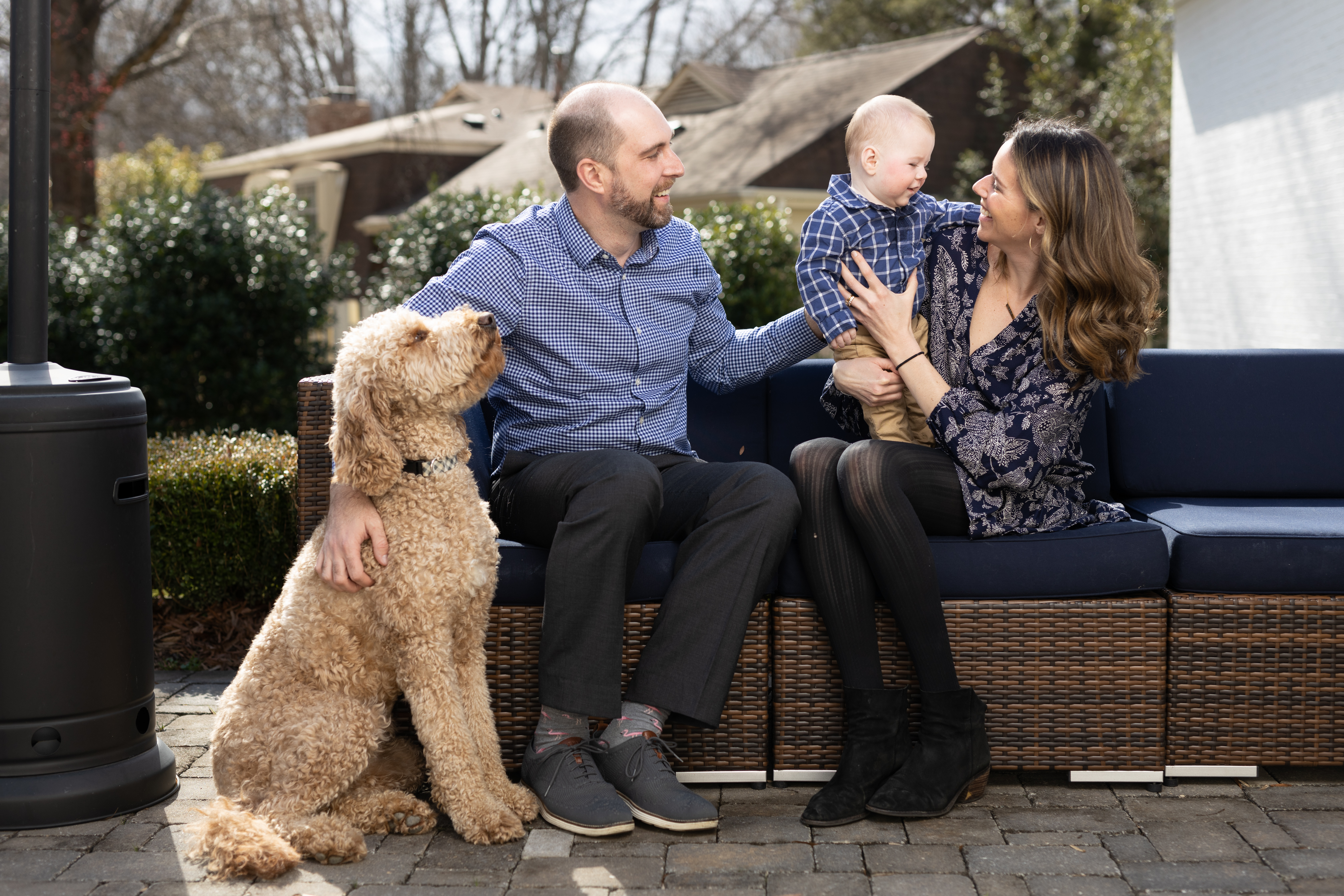 EMBA graduate Kyle Sweeney with his wife, baby, and dog