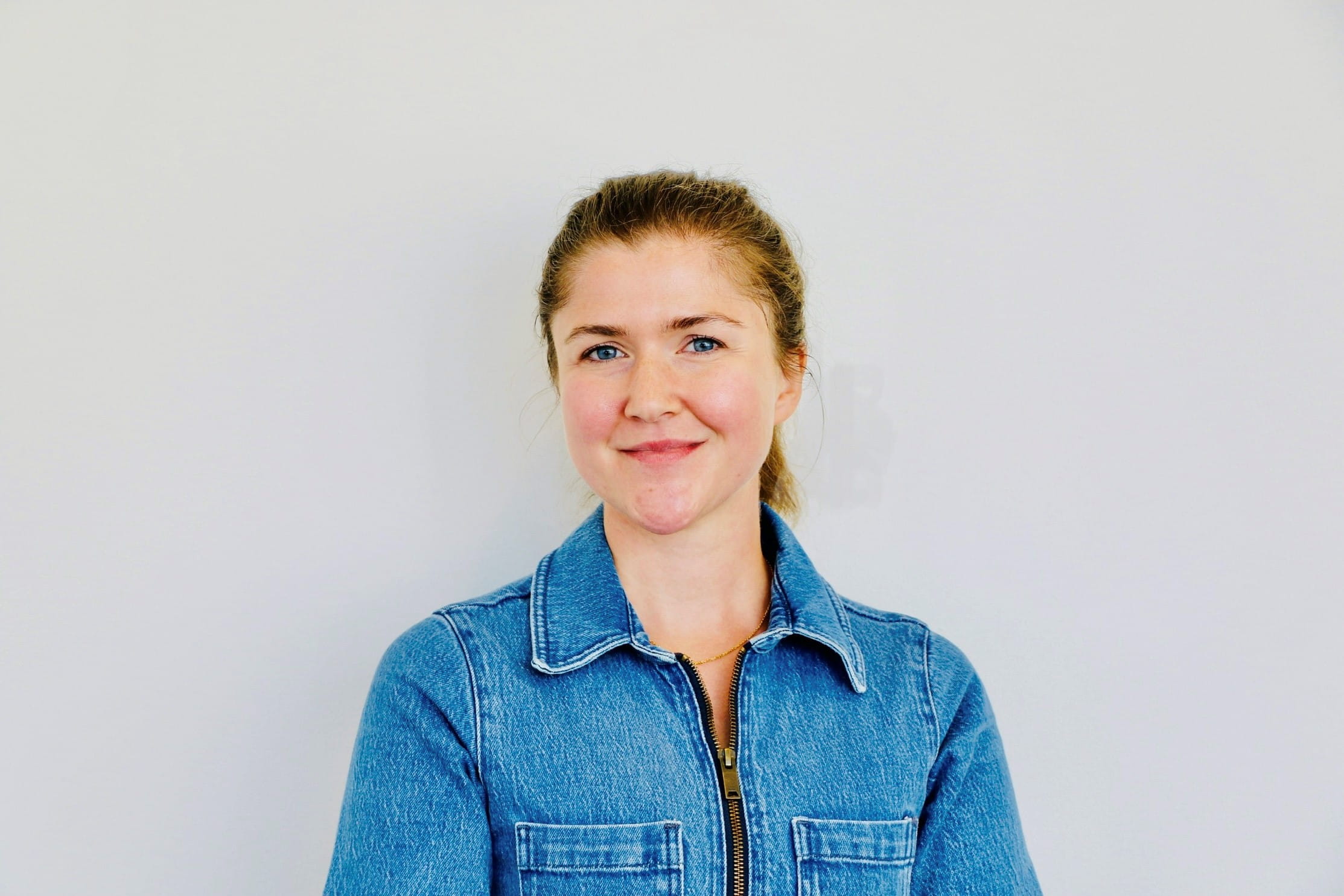Head shot of a woman wearing a blue shirt 