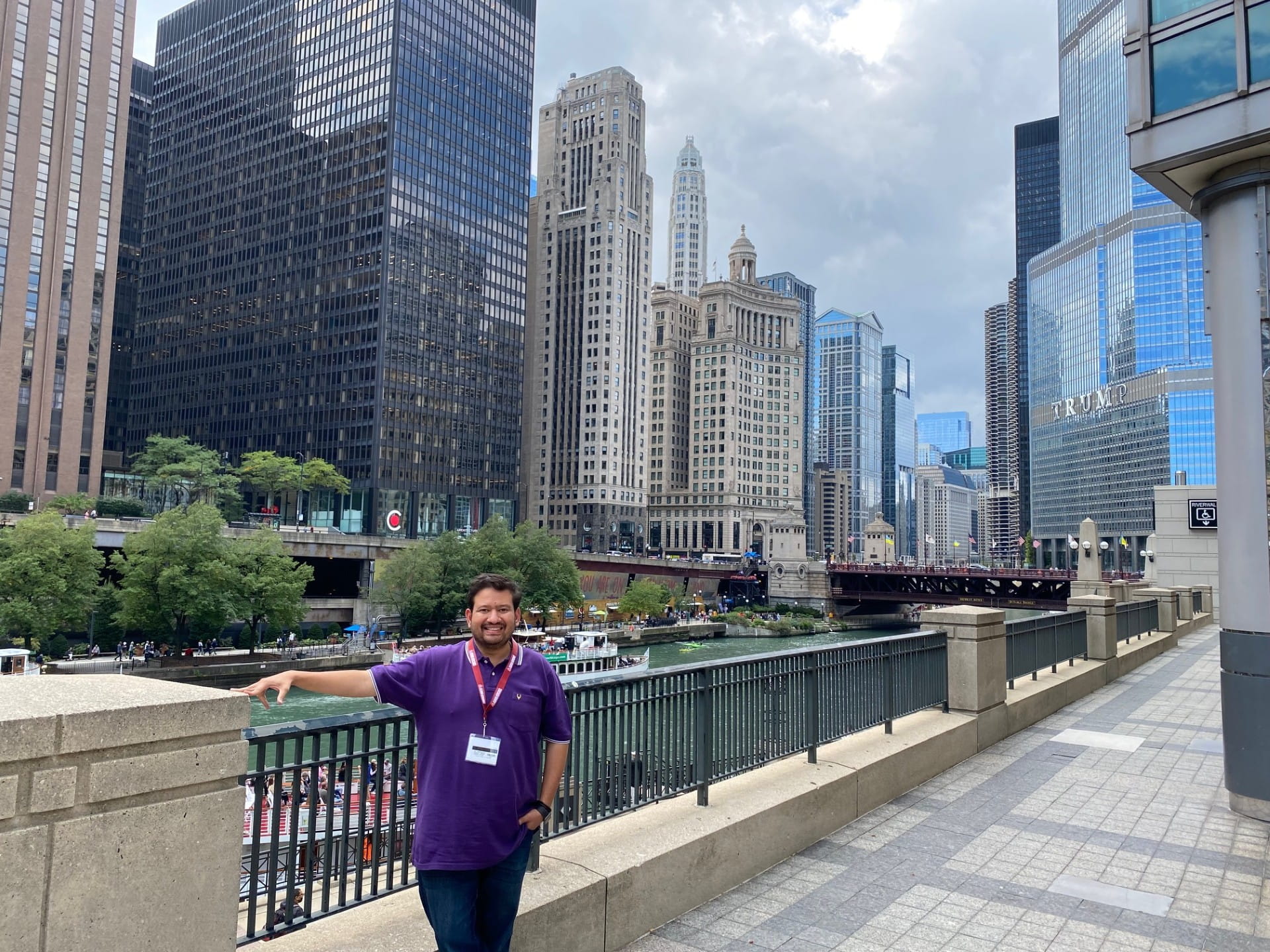 A man standing in front of the Chicago River