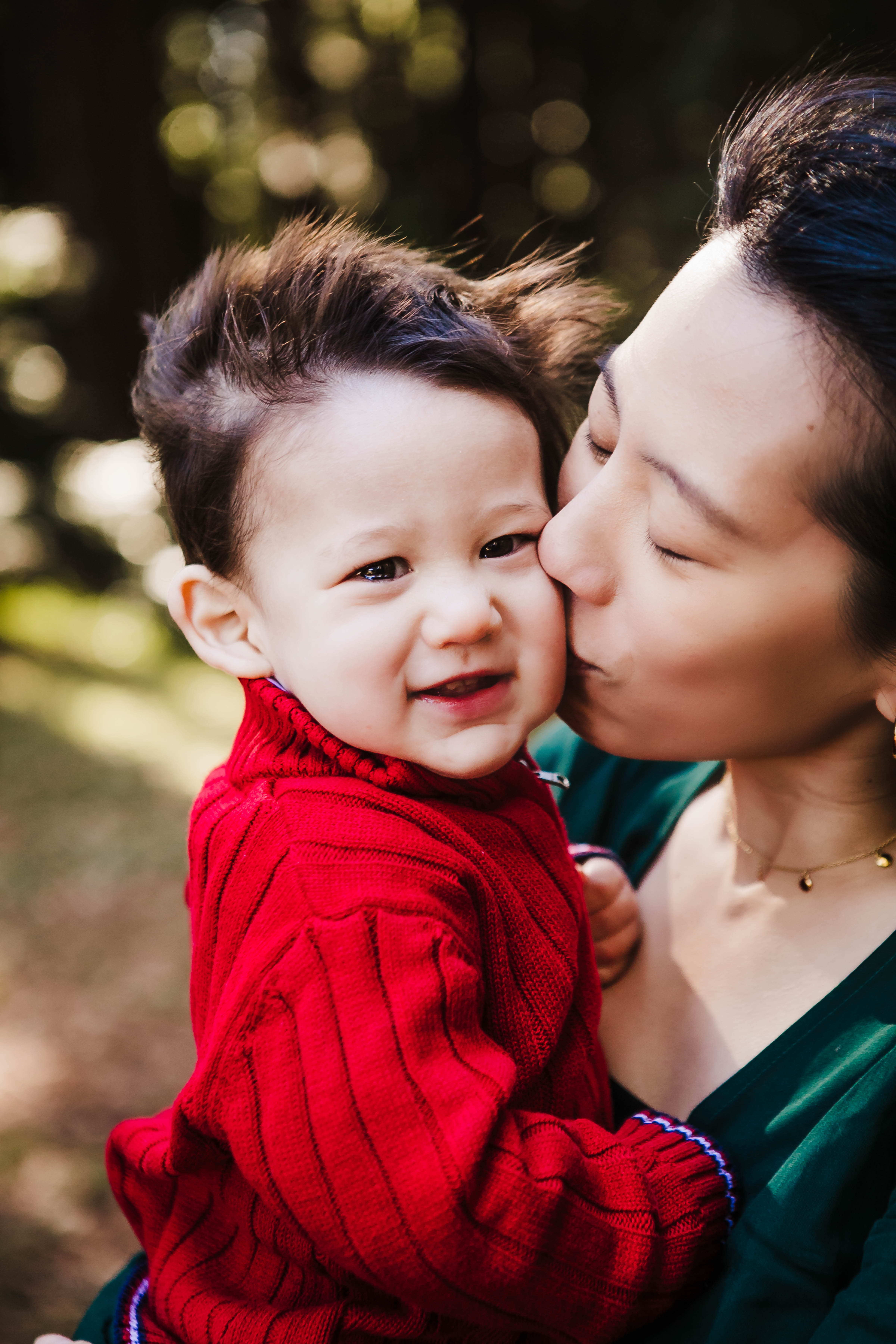 Woman kissing her young child