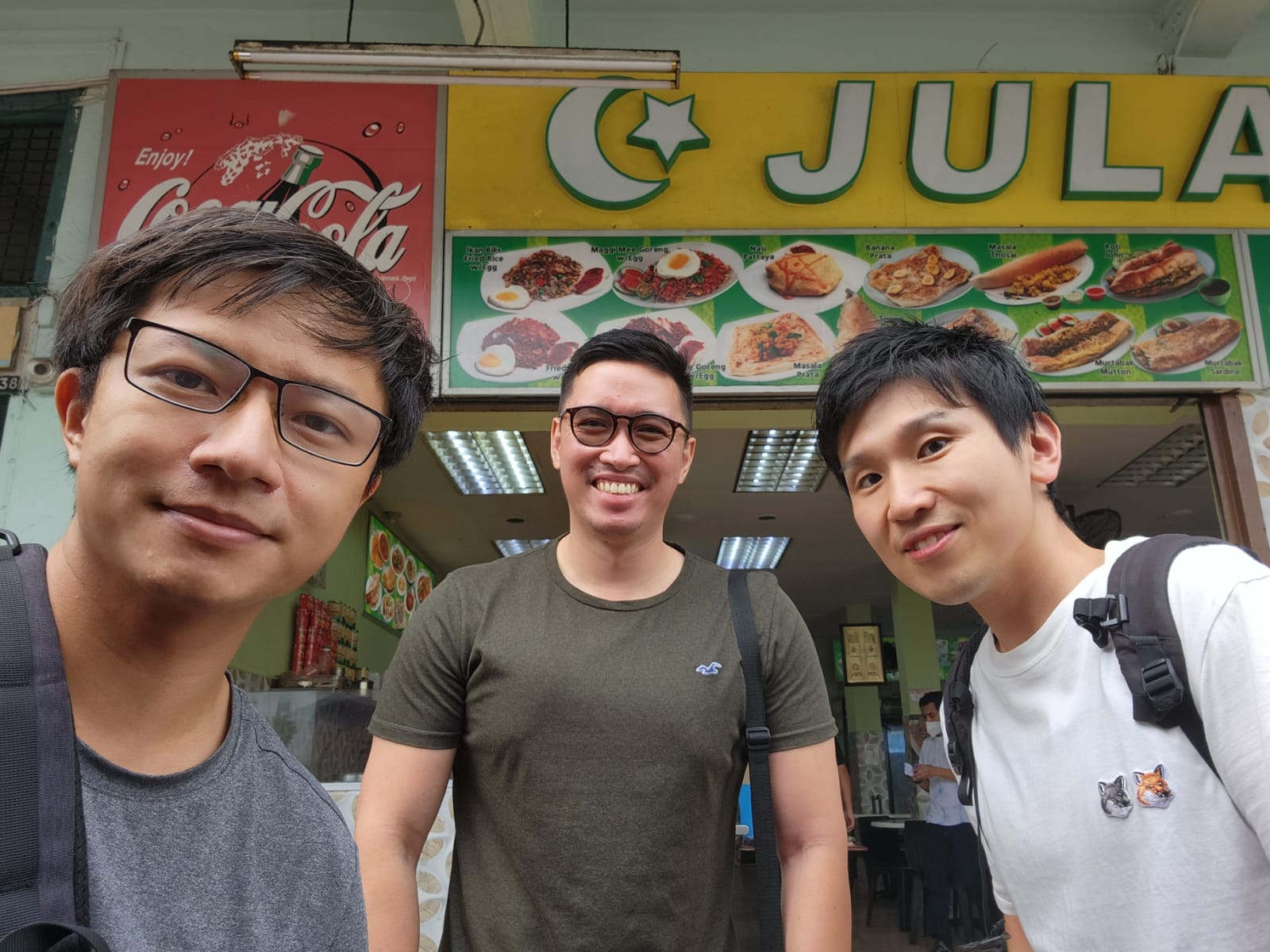 Three men smiling at the camera