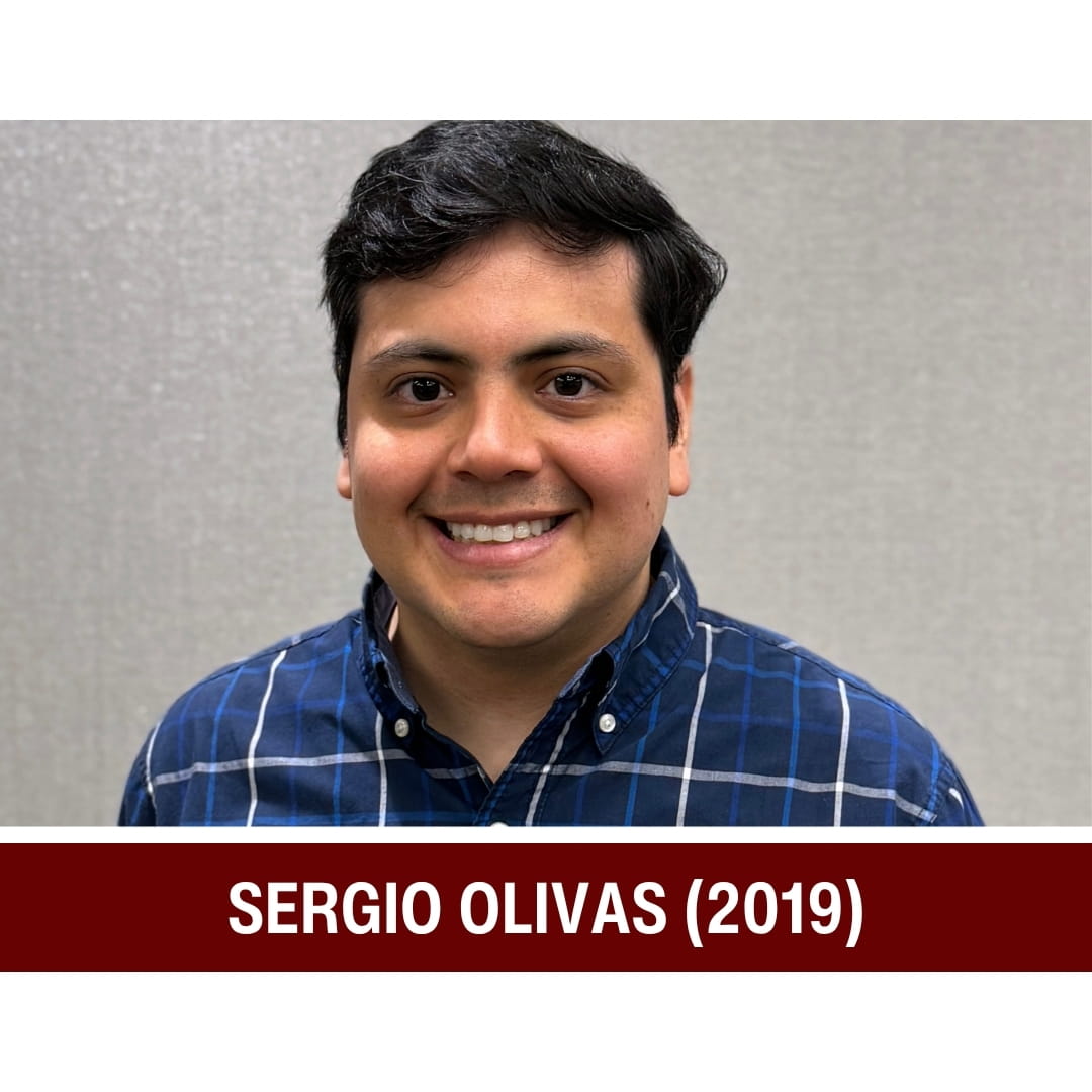 Picture of smiling dark-haired man wearing a blue striped shirt and standing in front of a grey background. A red strip beneath the picture is overlaid with white text that reads: Sergio Olivas (2019)