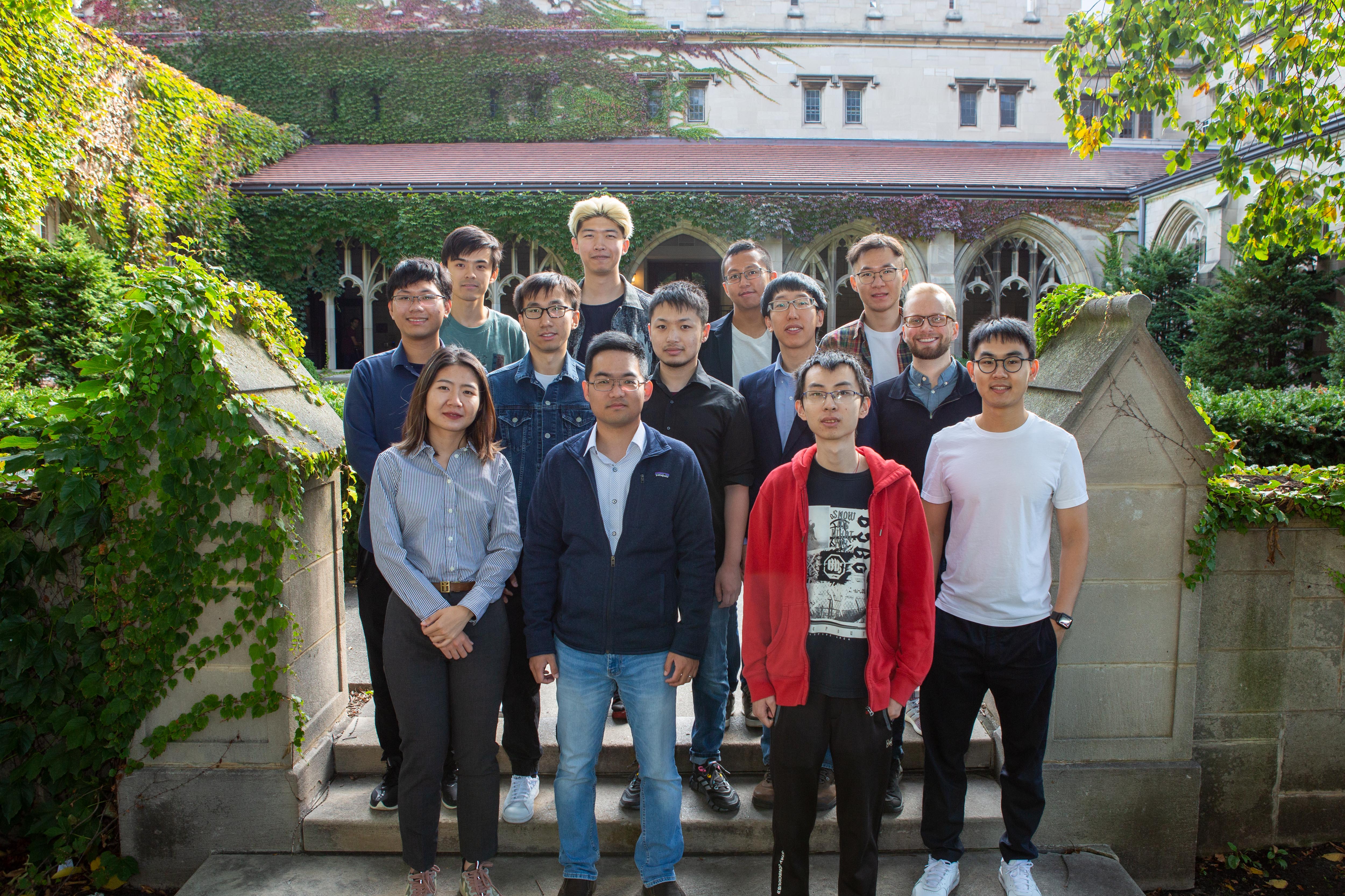 Group photo of E&S students standing in front of summer garden
