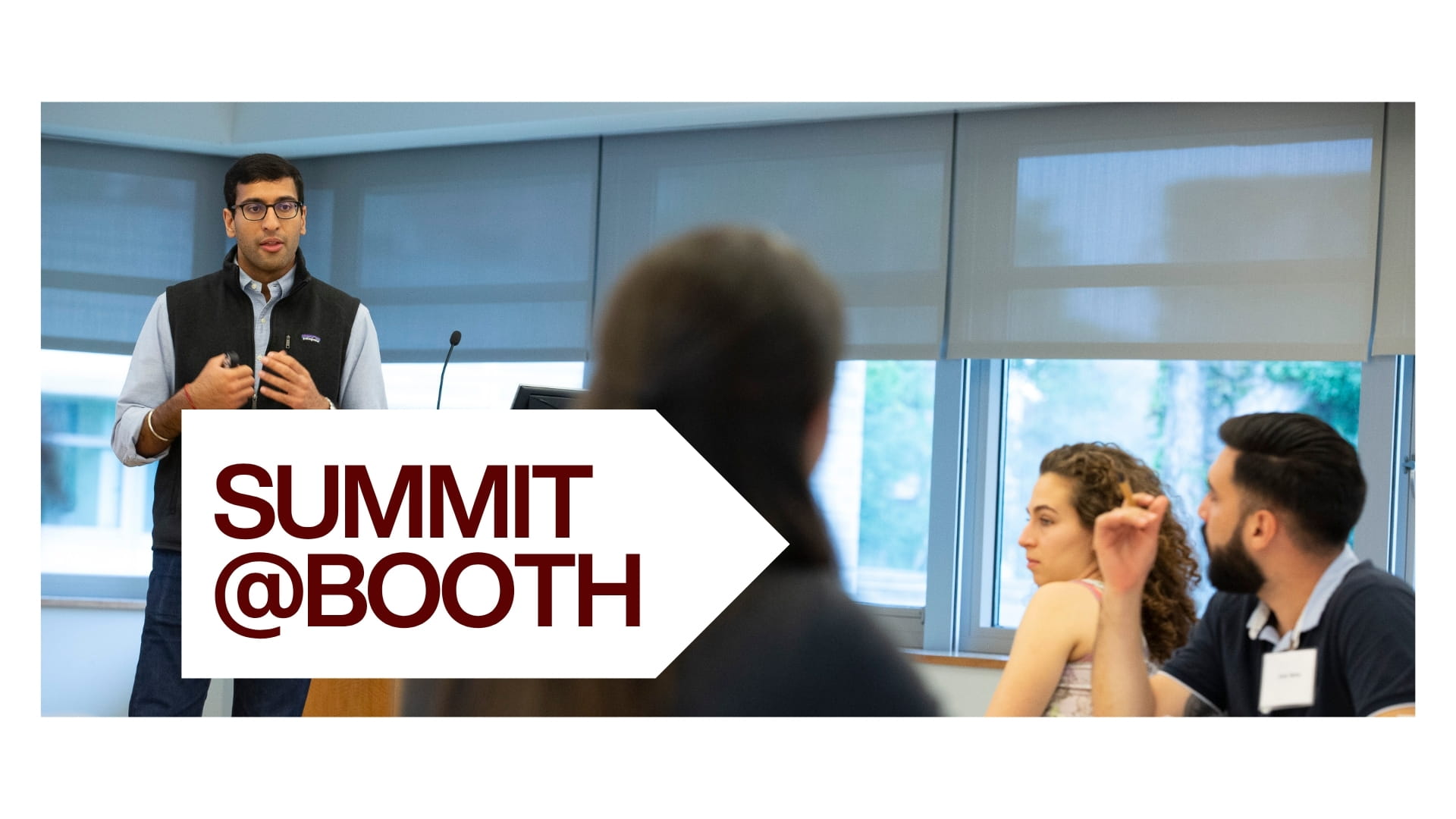 Image of brown-haired student presenter in front of a group of students. A white arrow box is overlaid over the image. The text reads: Summit@Booth, Nov 10-11, 2025. 