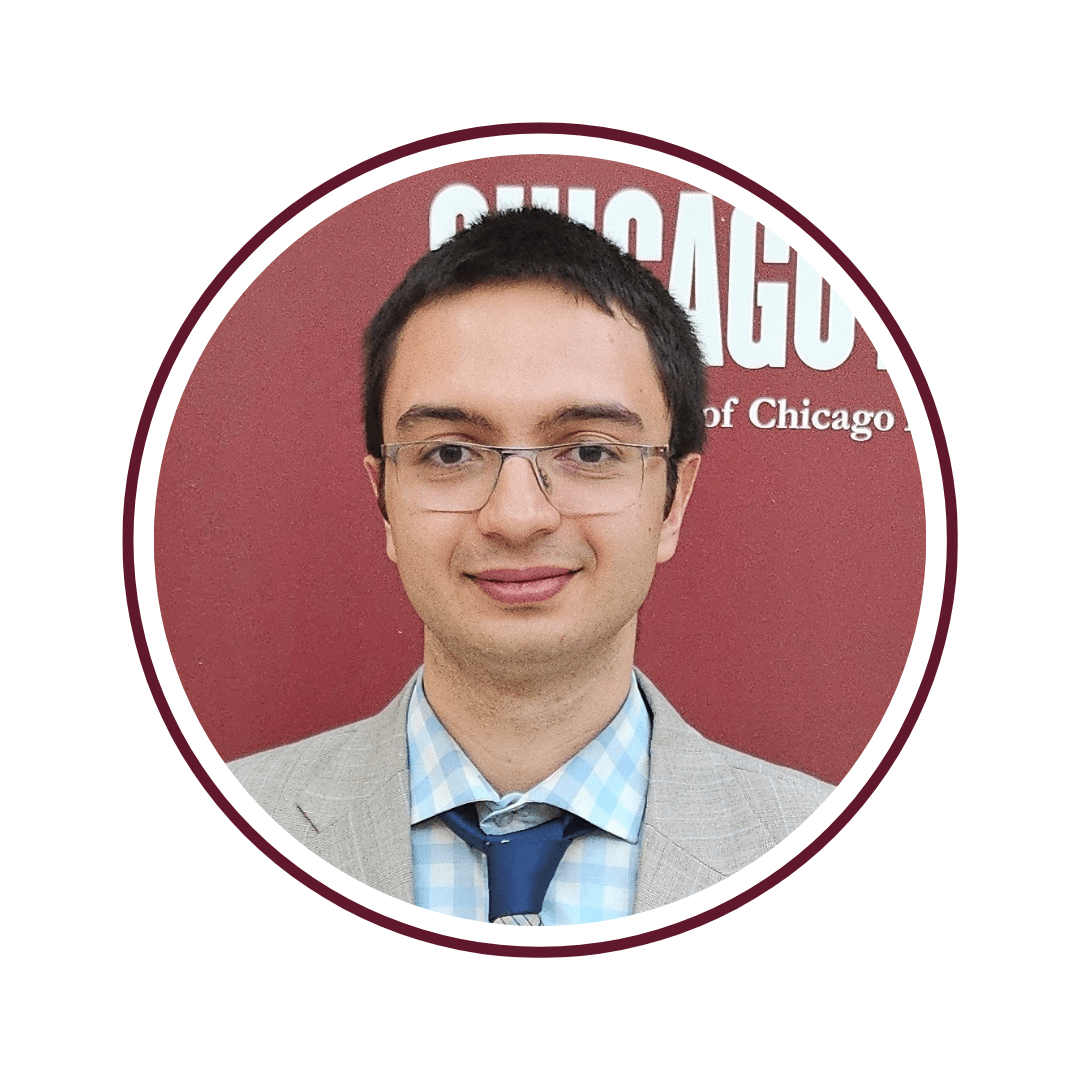 Picture of a dark haired man with glasses in a tan suit. Picture has a maroon frame.