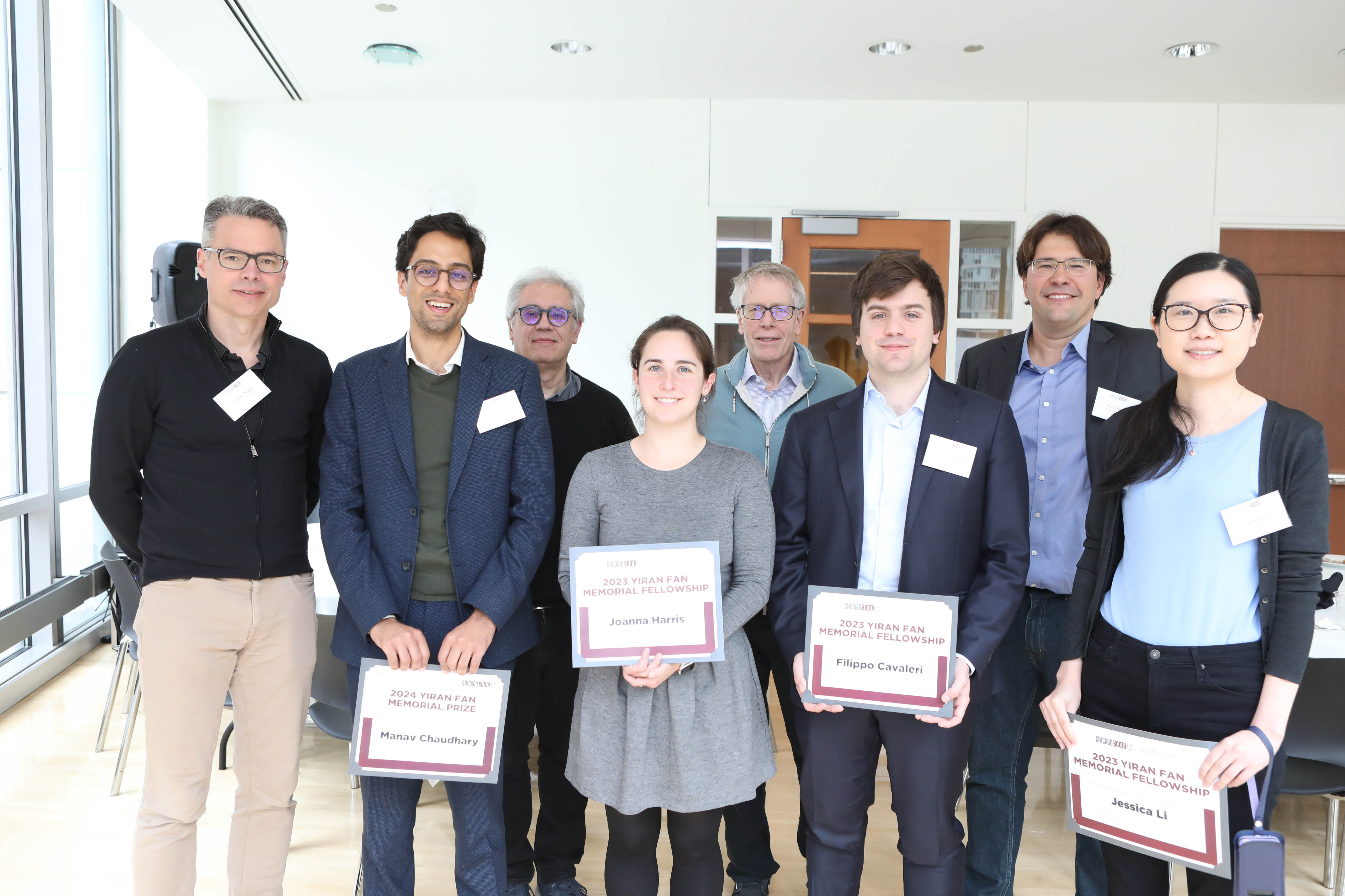 Group photo of Yiran Fan conference attendees standing together and holding certificates