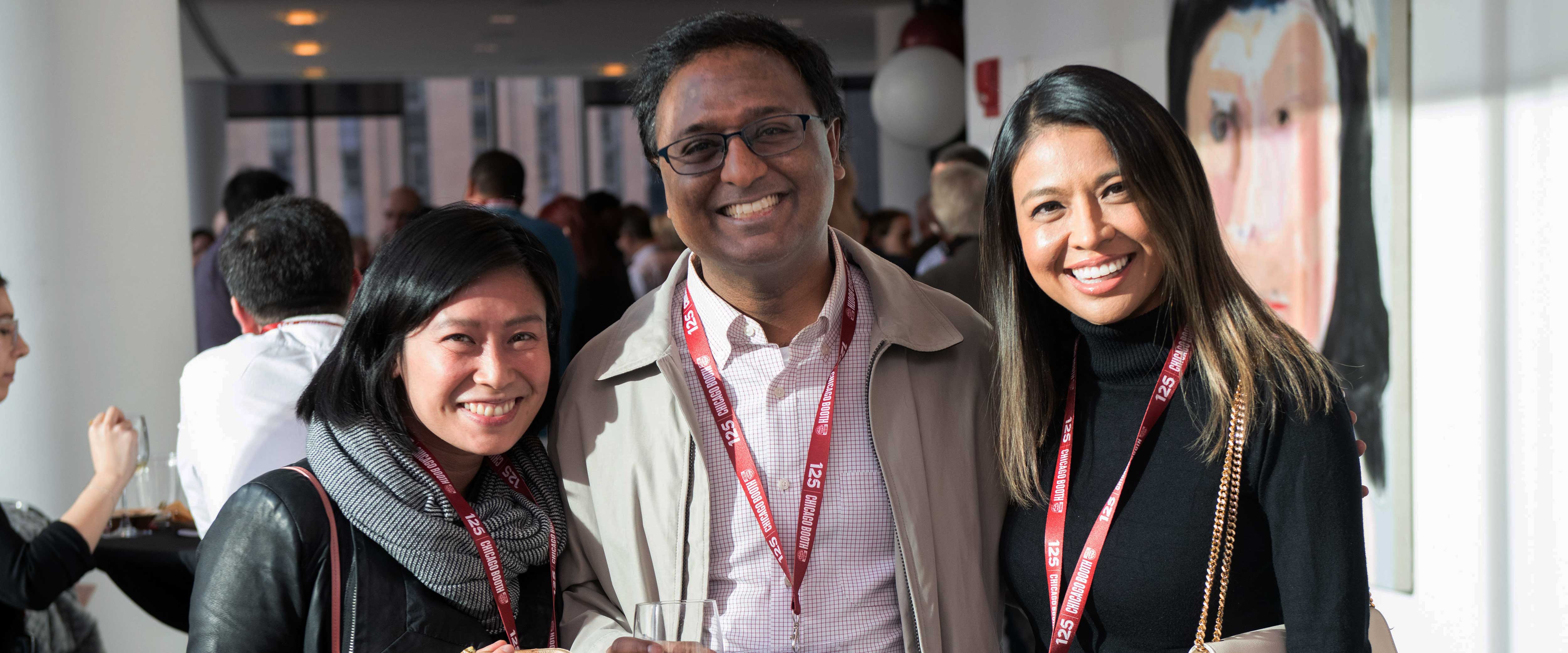 Three Chicago Booth alumni posing for a photo