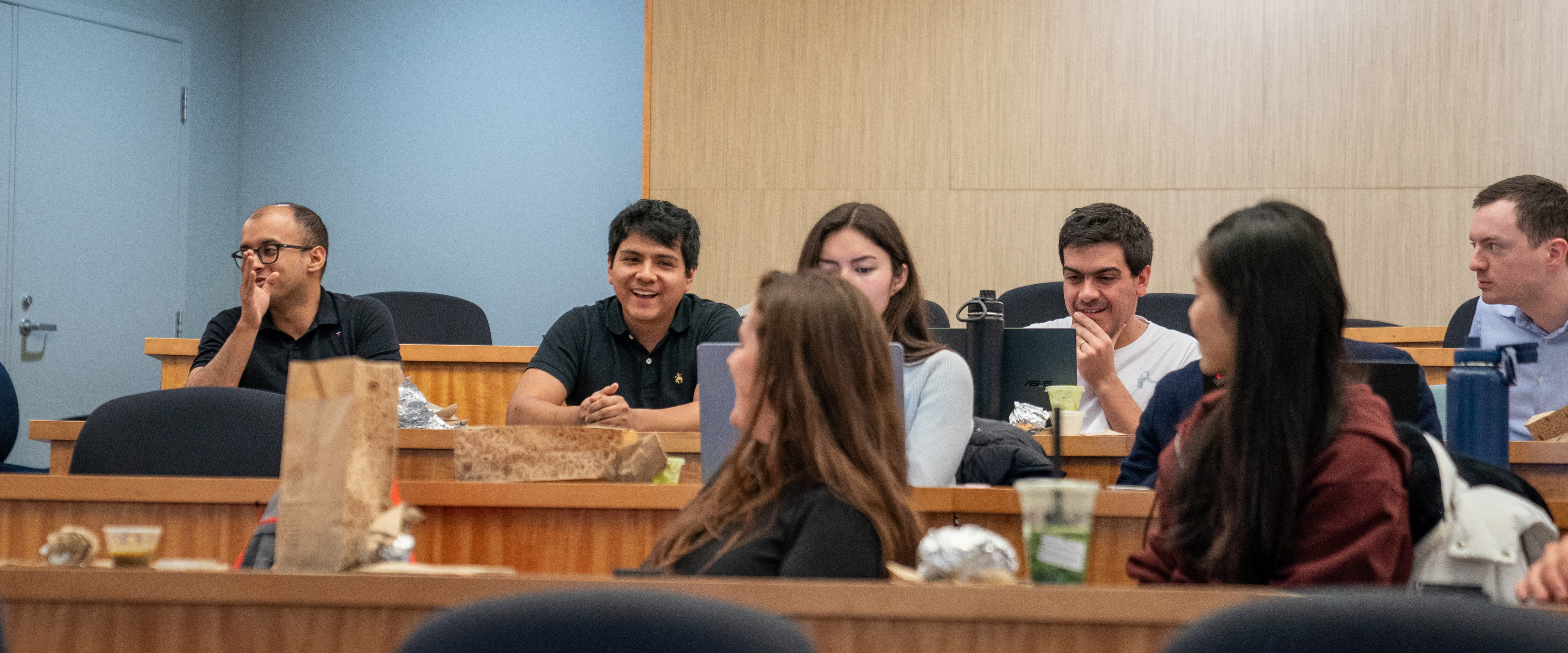 Students talking with each other in a classroom discussion.
