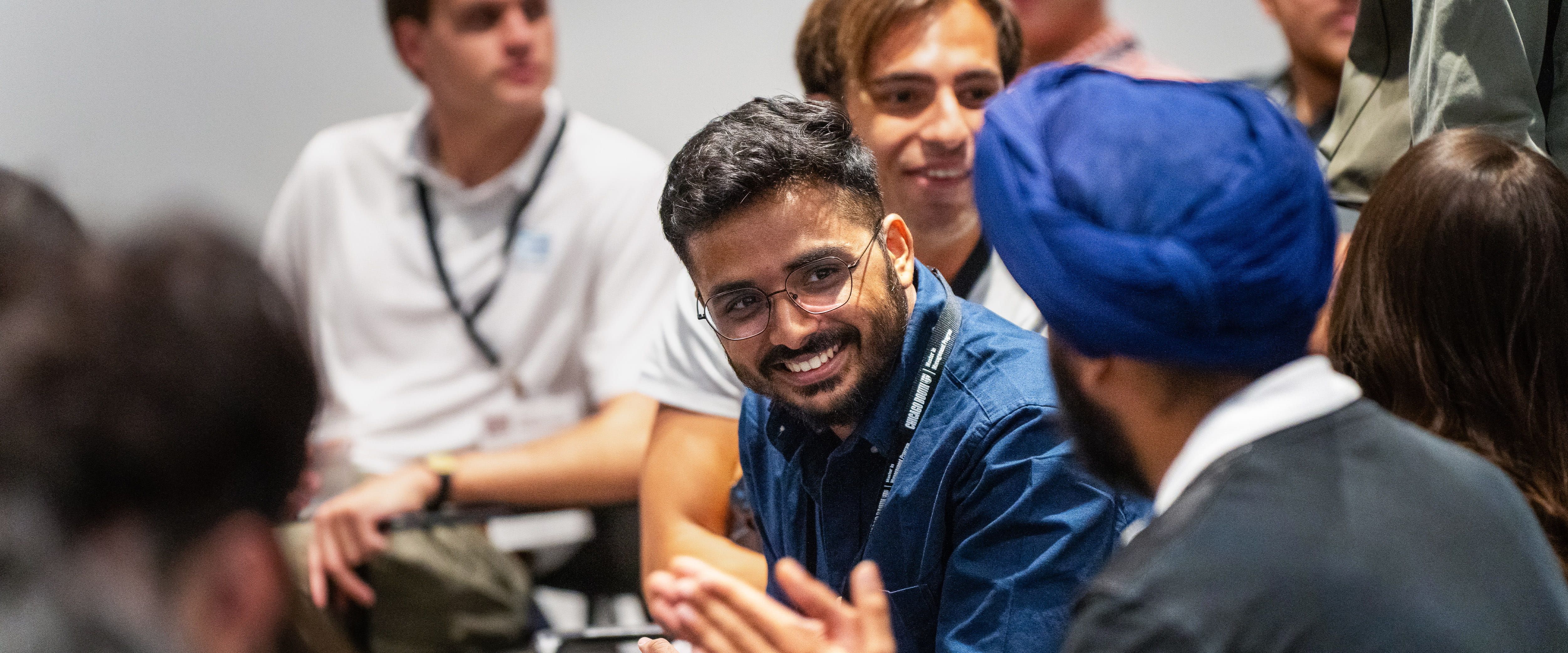 Students talking and smiling together during event.