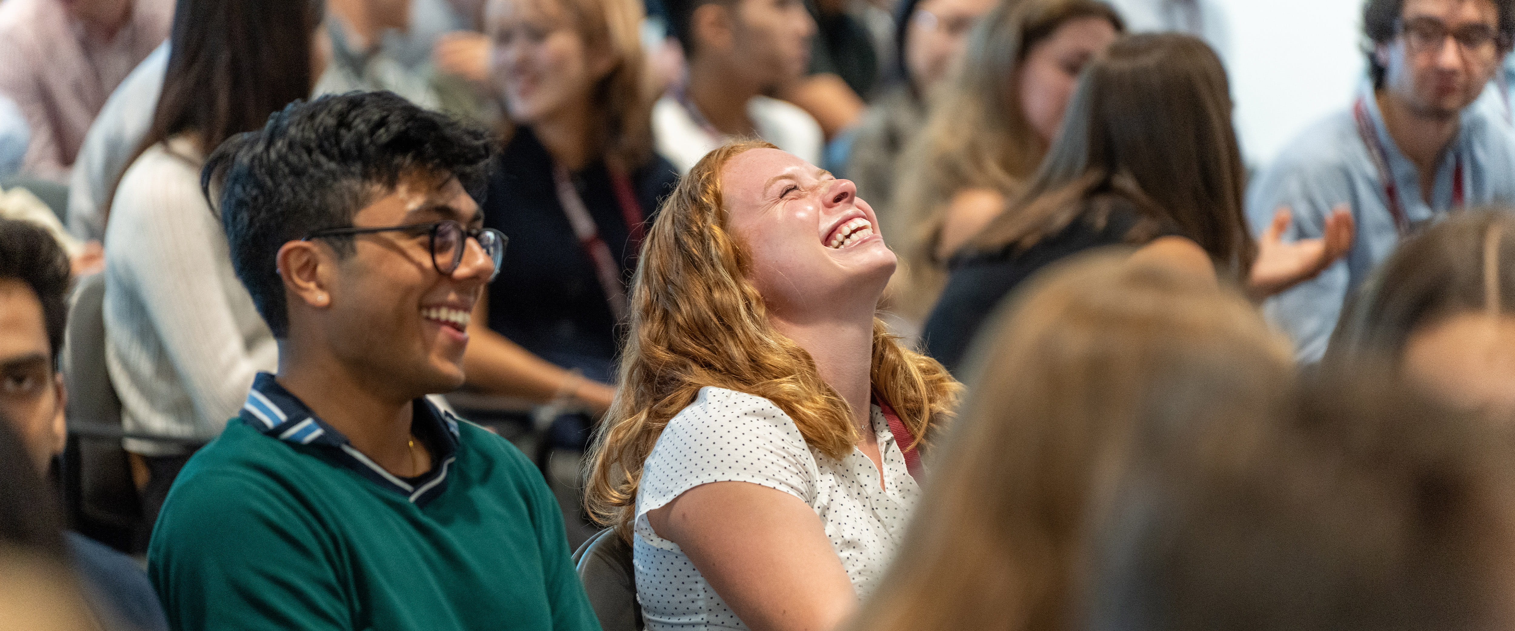 Students smiling during Booth camp lecture. 