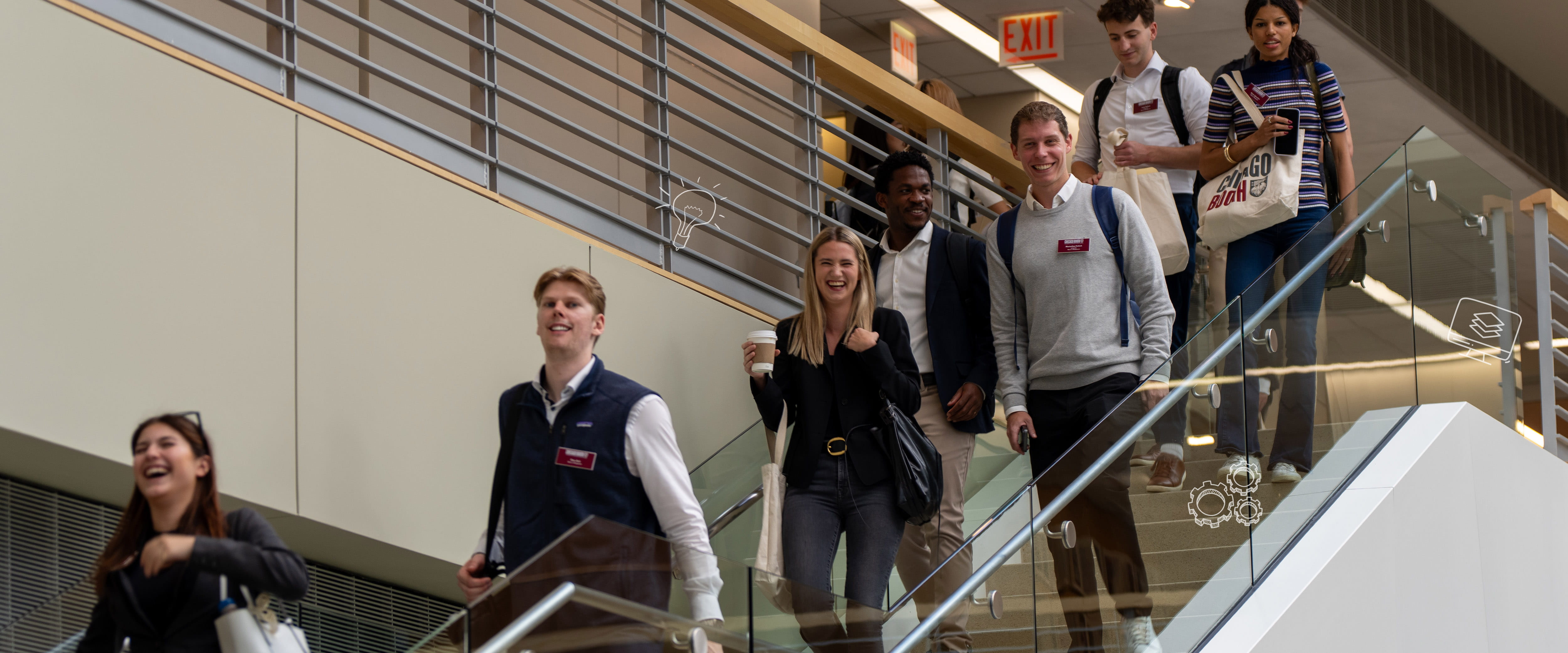 Students smiling as they walk down stairs.