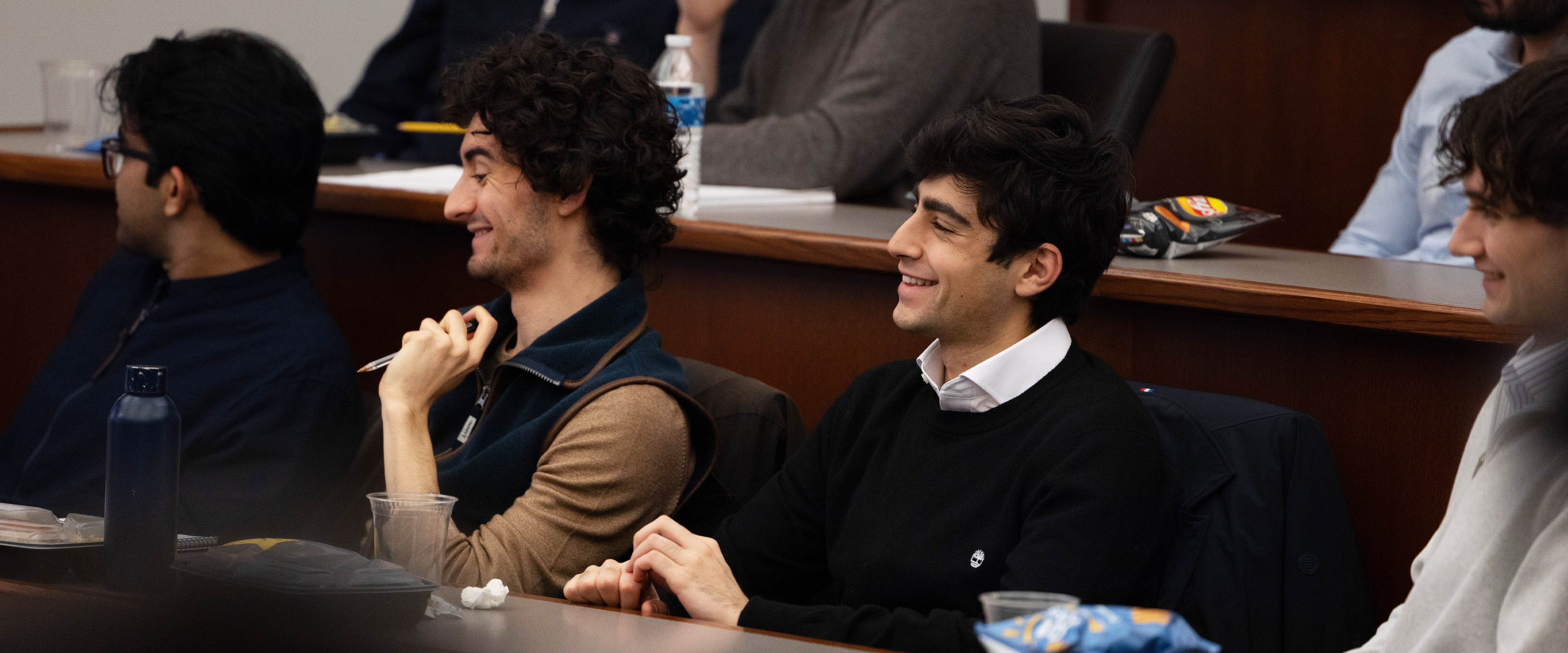 Students smiling as they listen during class.