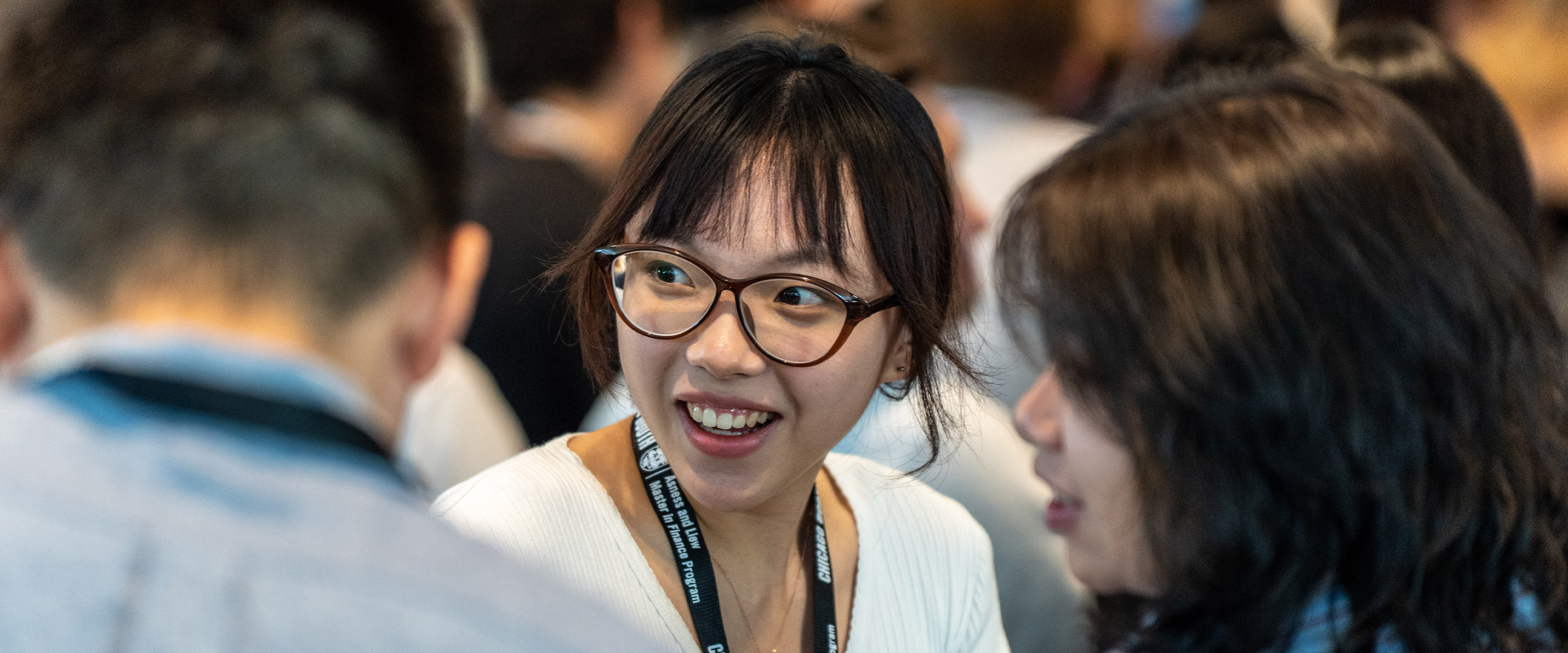 Student looking back, discussing with others.