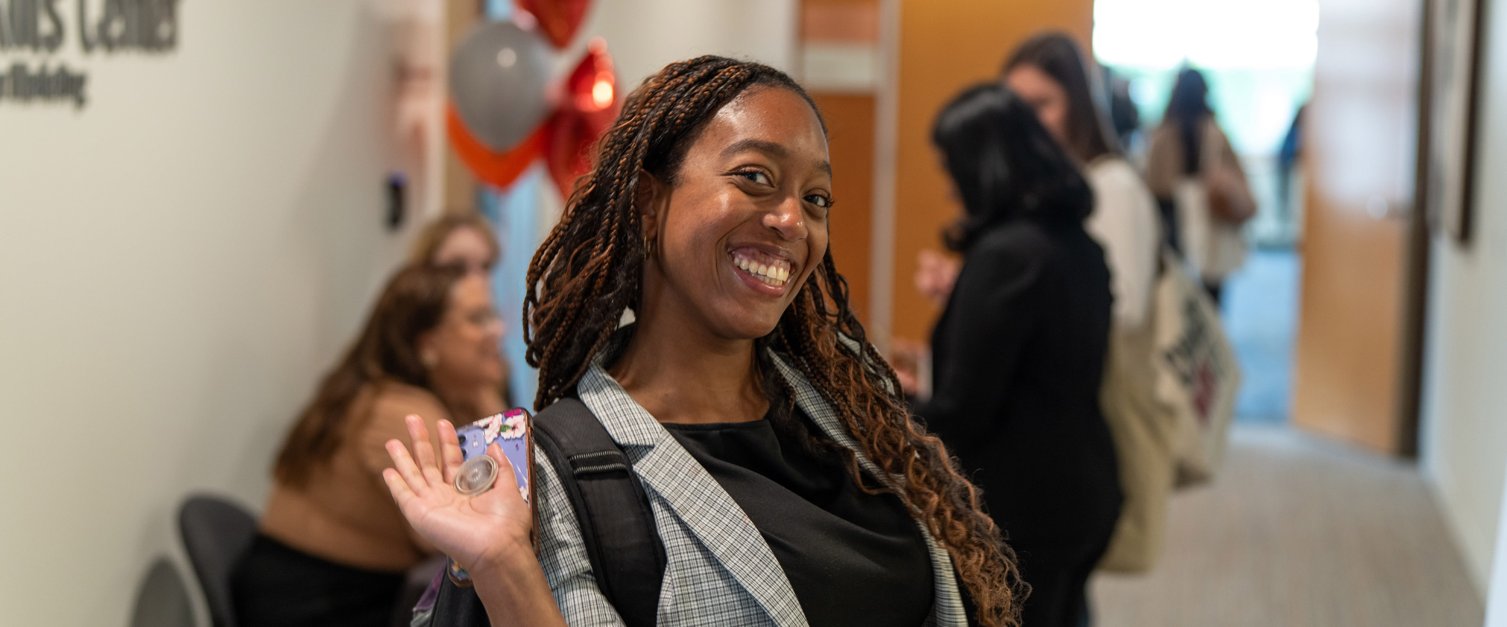 Student waving at camera.