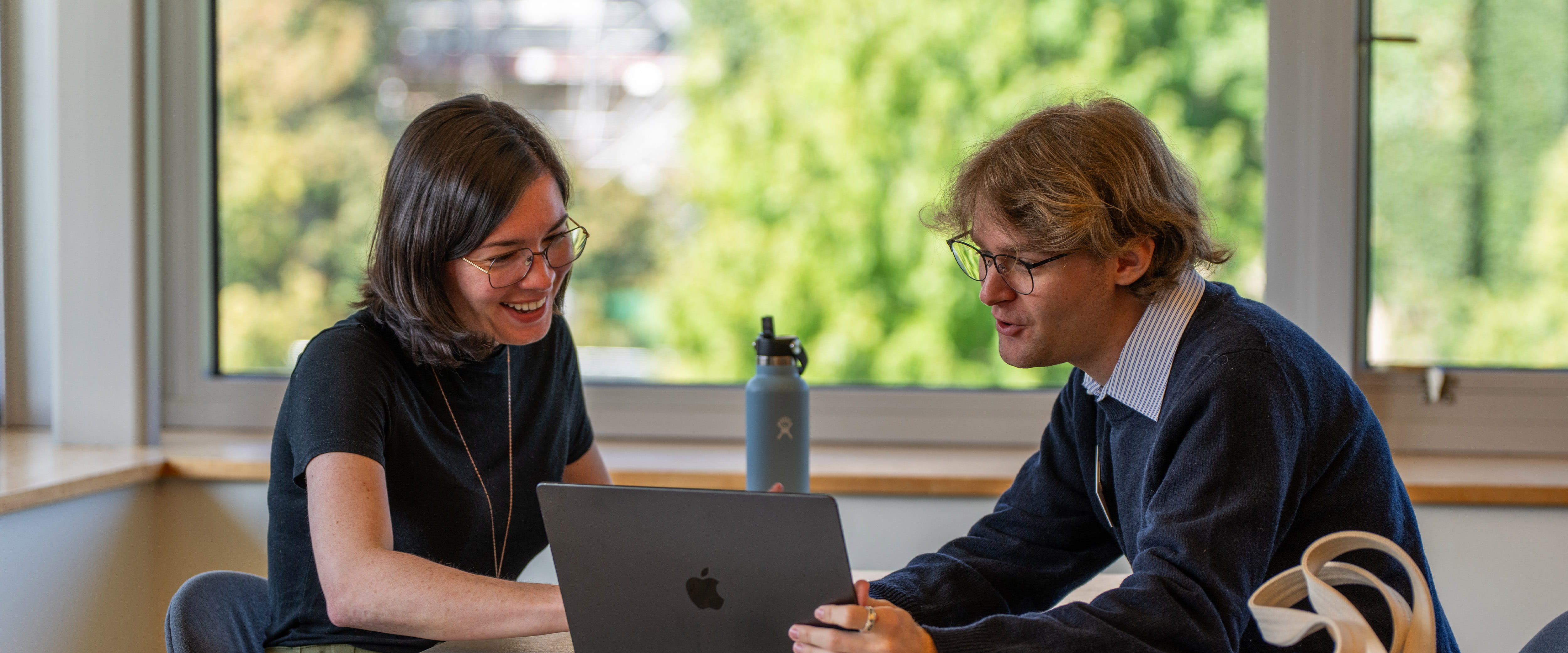 Student and staff looking at laptop to help pick electives