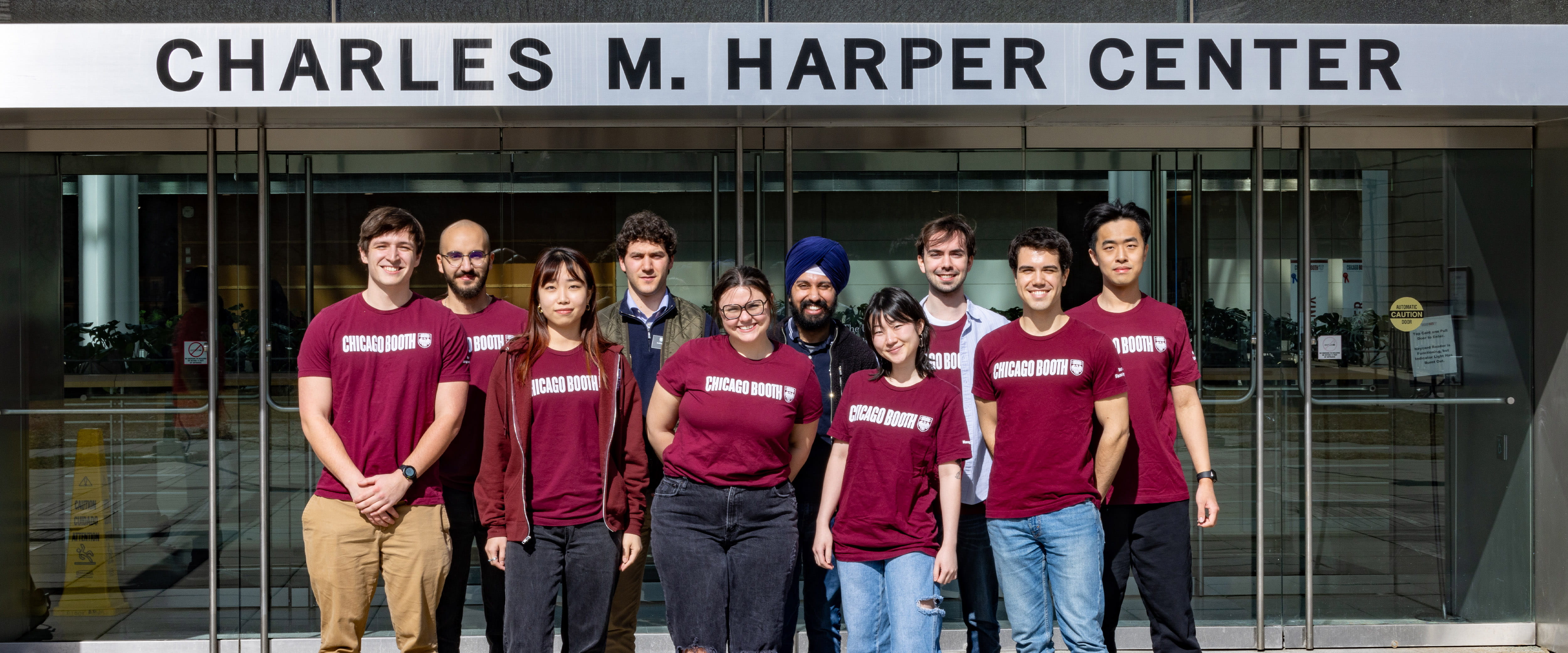 Group of students in Booth gear talking a group photo together.