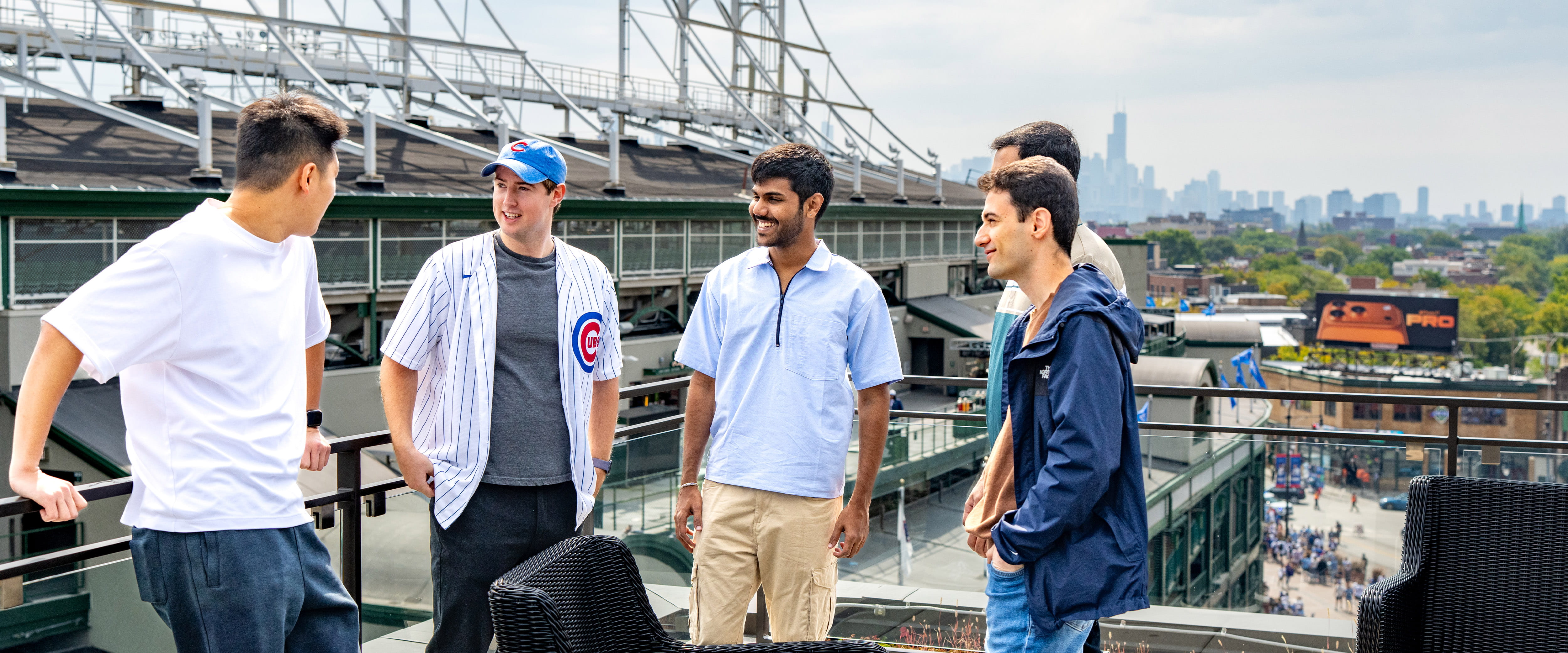 Group of student in front of the Cubs stadium socializing.