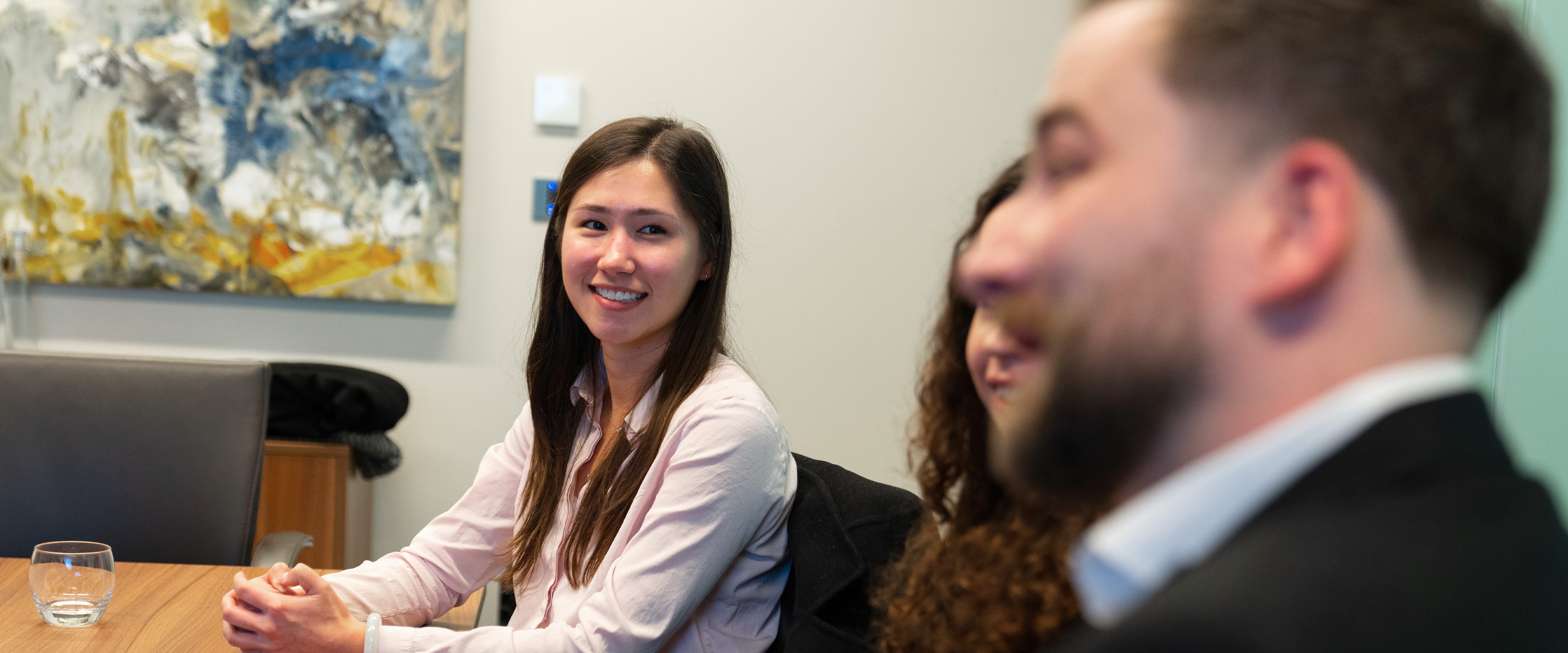 Student talking with recruiters at their office