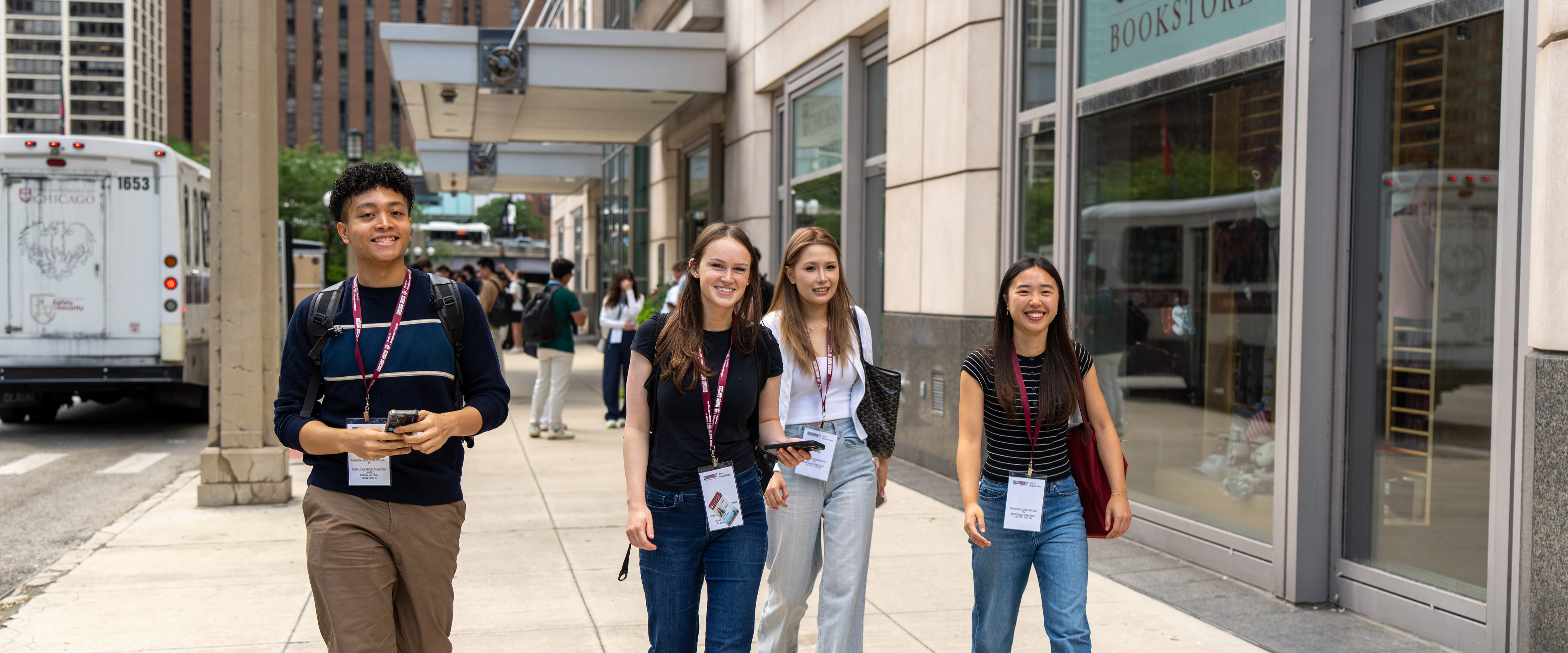 Special Master students walking and smiling in front of the Gleacher Center