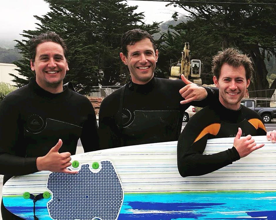 Luca Ferrara with friends and a surfboard