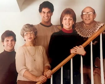 Selwyn Becker, far right, posing with his wife and three children going of a bannister in a house in 1983