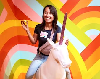 Shi-Wei Toh on a white unicorn holding a pastry