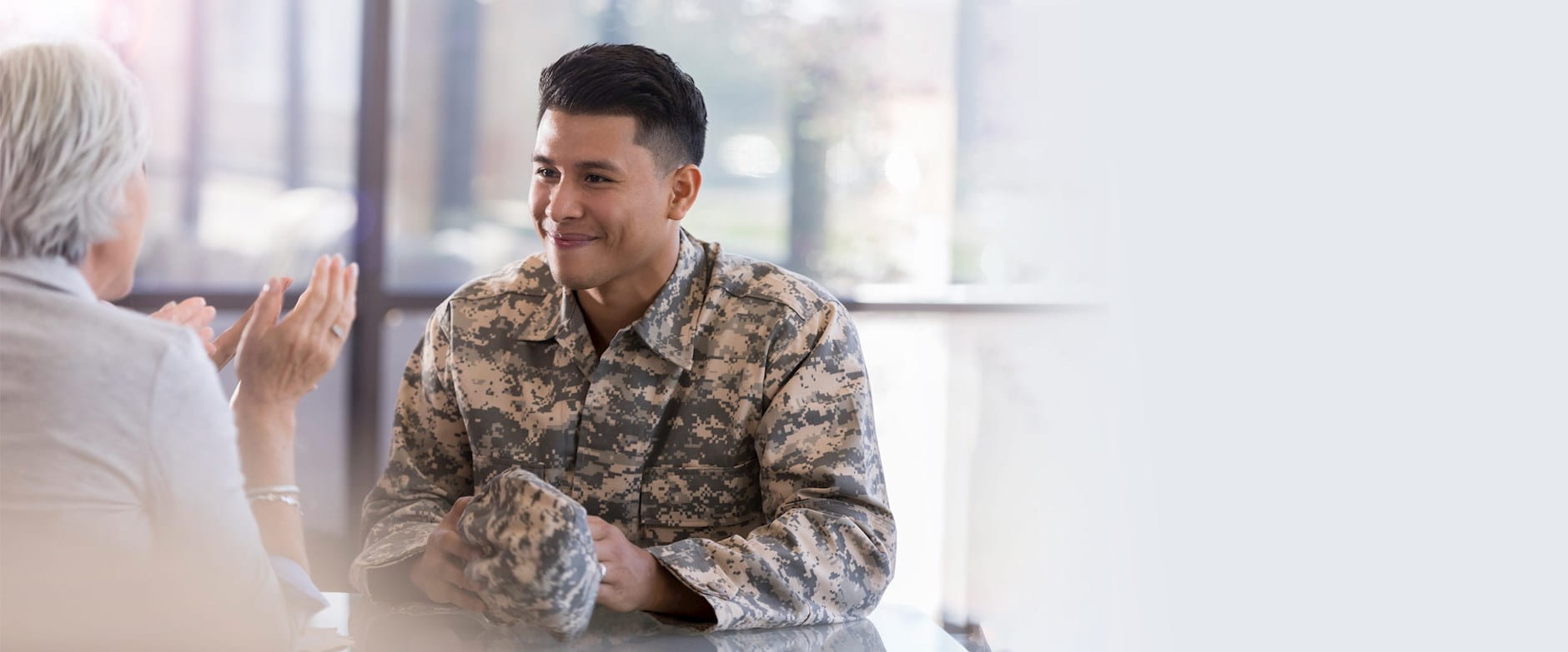 Smiling military man listening to woman