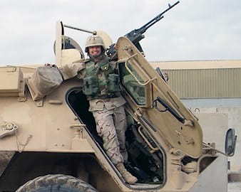 Soldier posing in front of a plantoon tank
