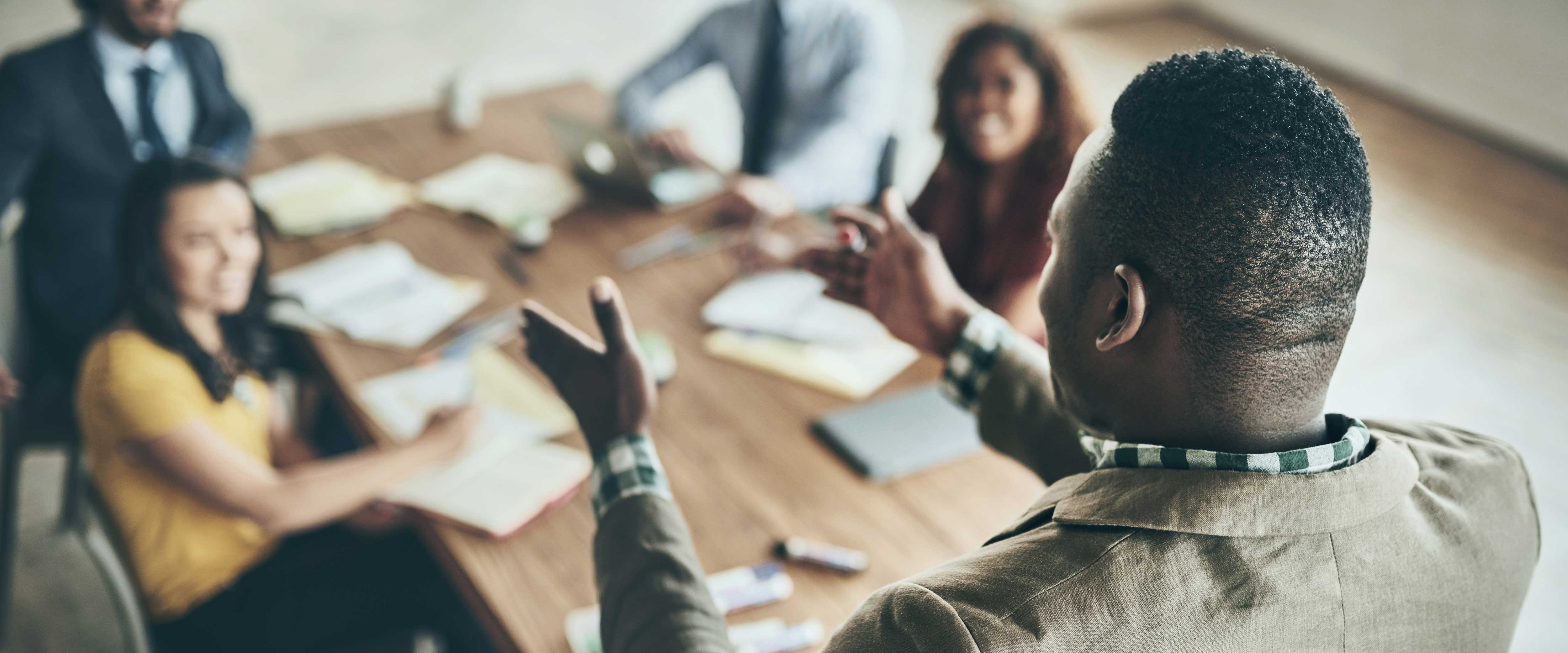 African American man leading a meeting