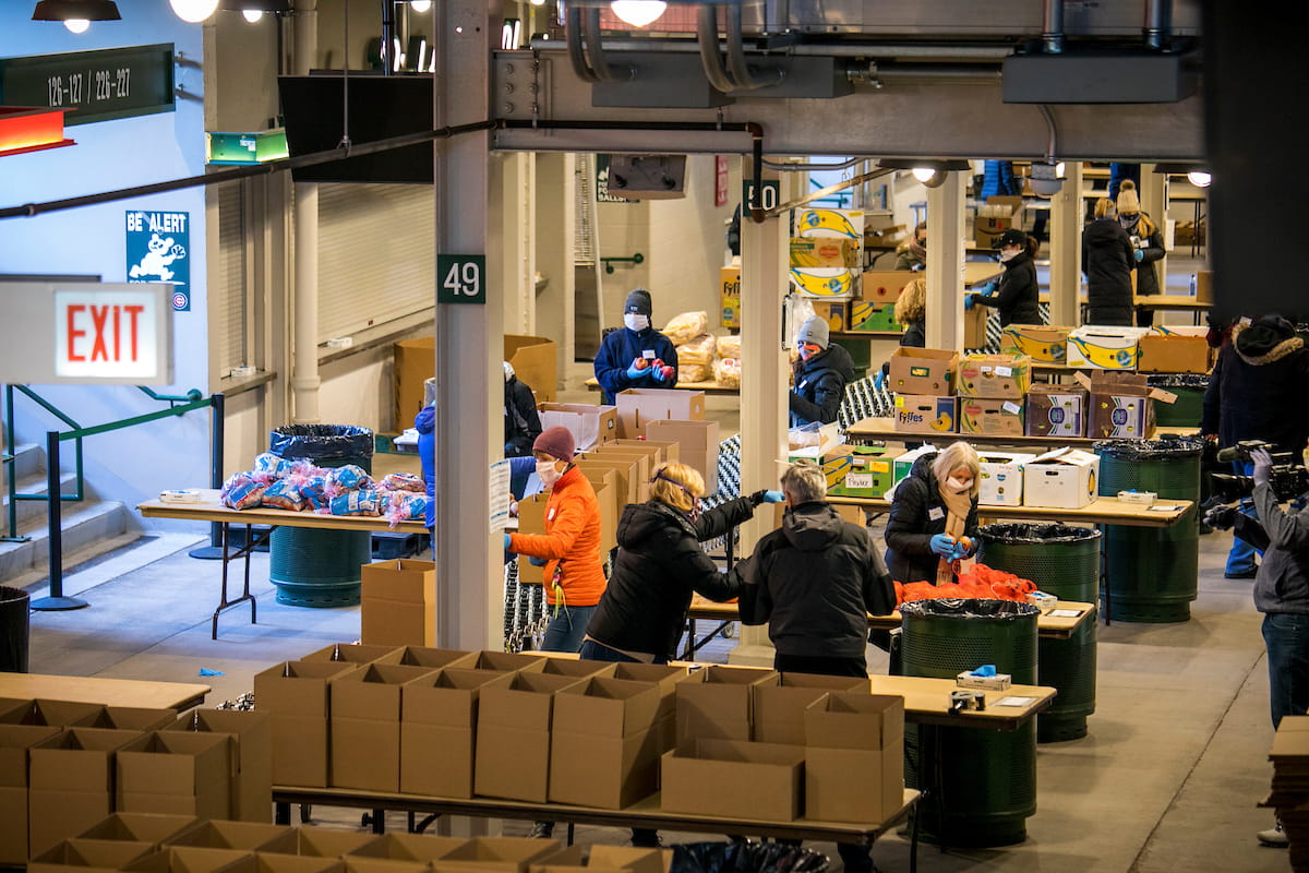 Food pantry volunteers working at a temporary location at Wrigley Field