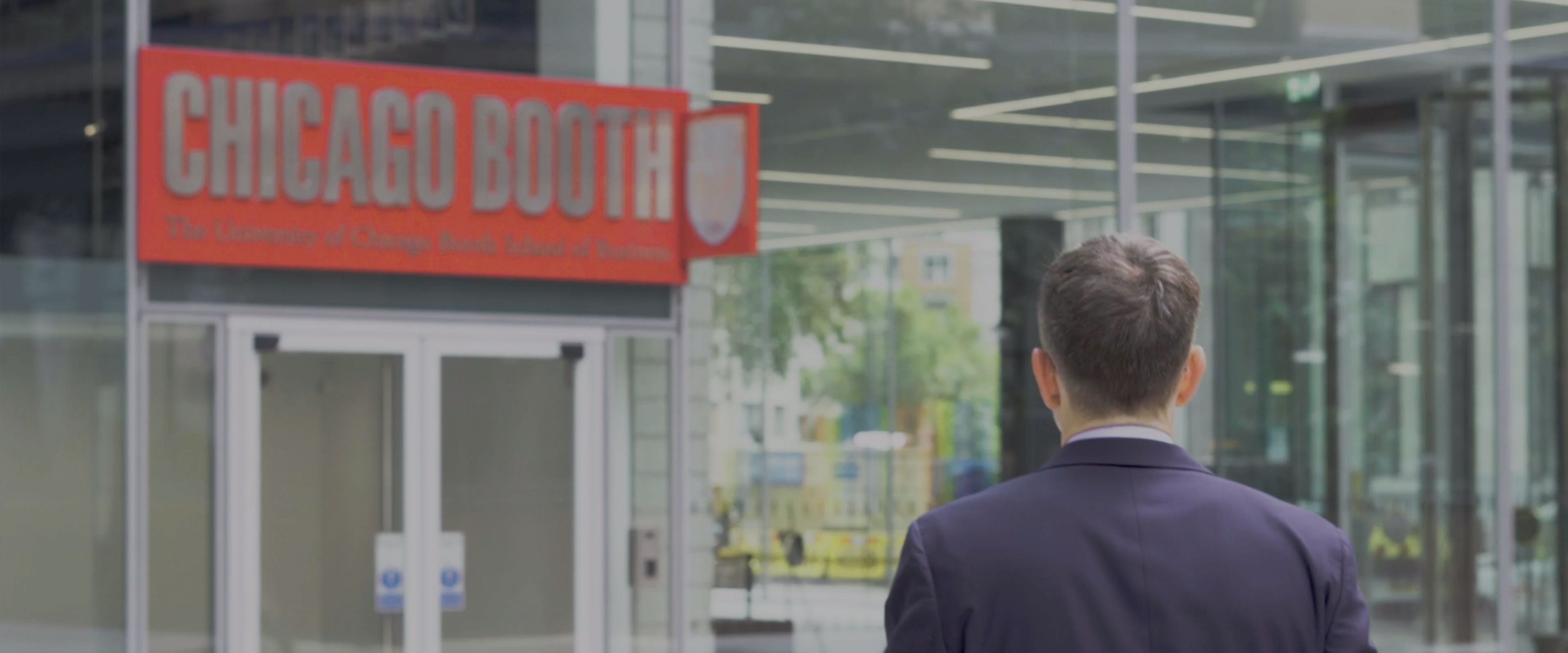 Man walking through the front door of Chicago Booth's London campus