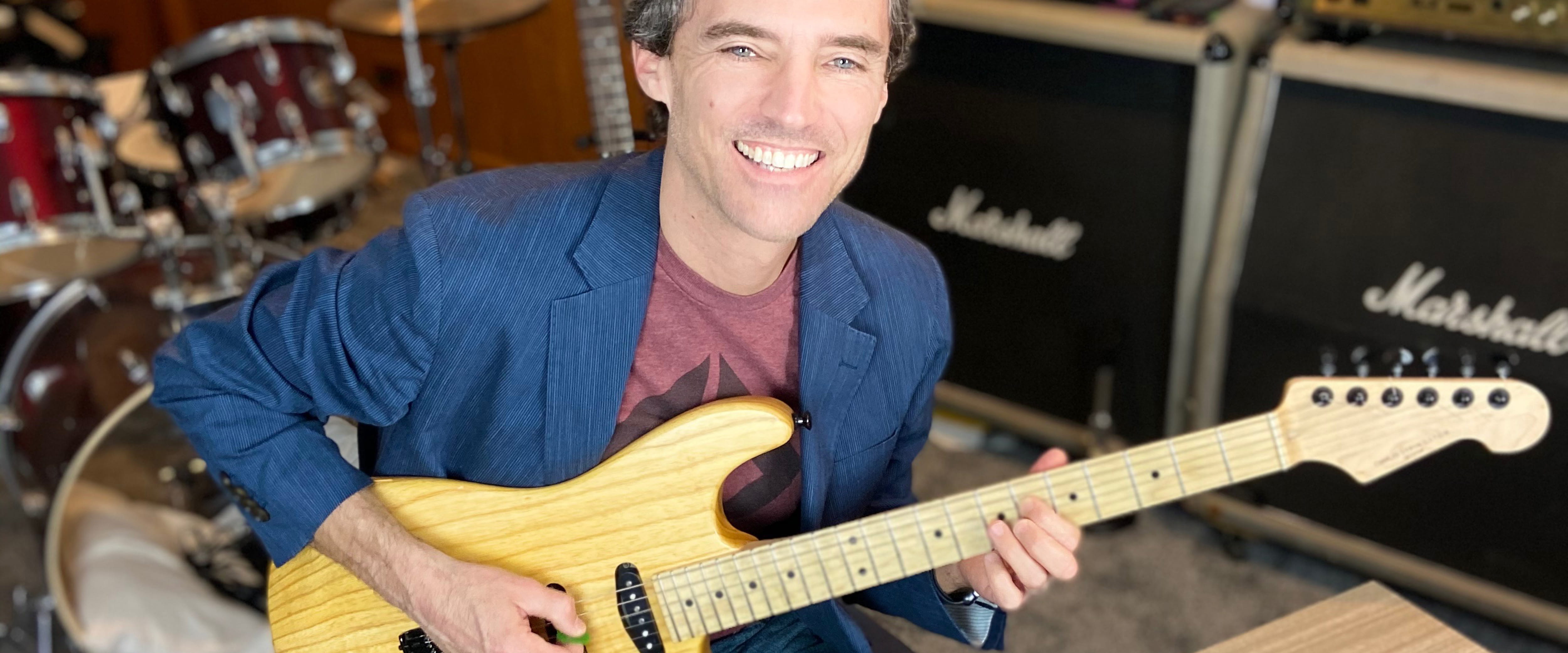 Stephen Kohler playing his guitar