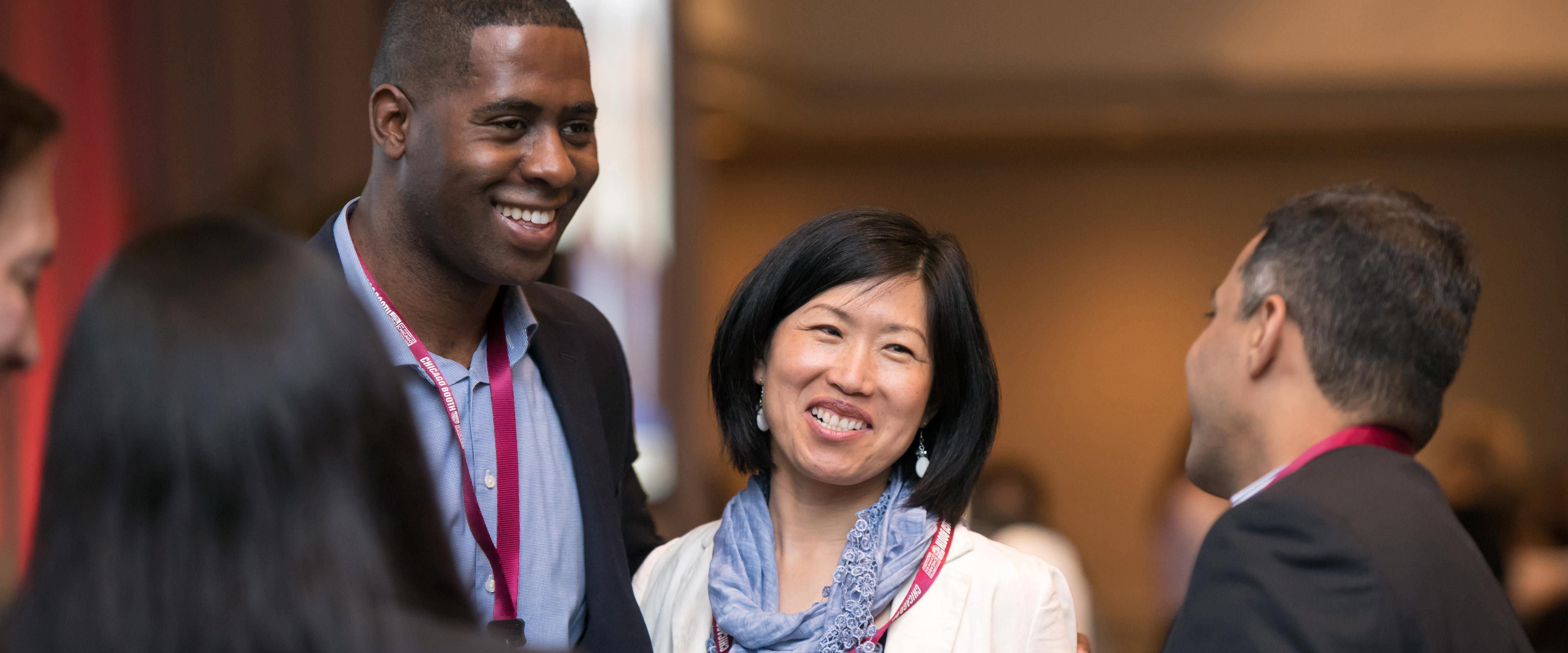 A group of networking alumni chatting in a small circle at Reconnect 2017