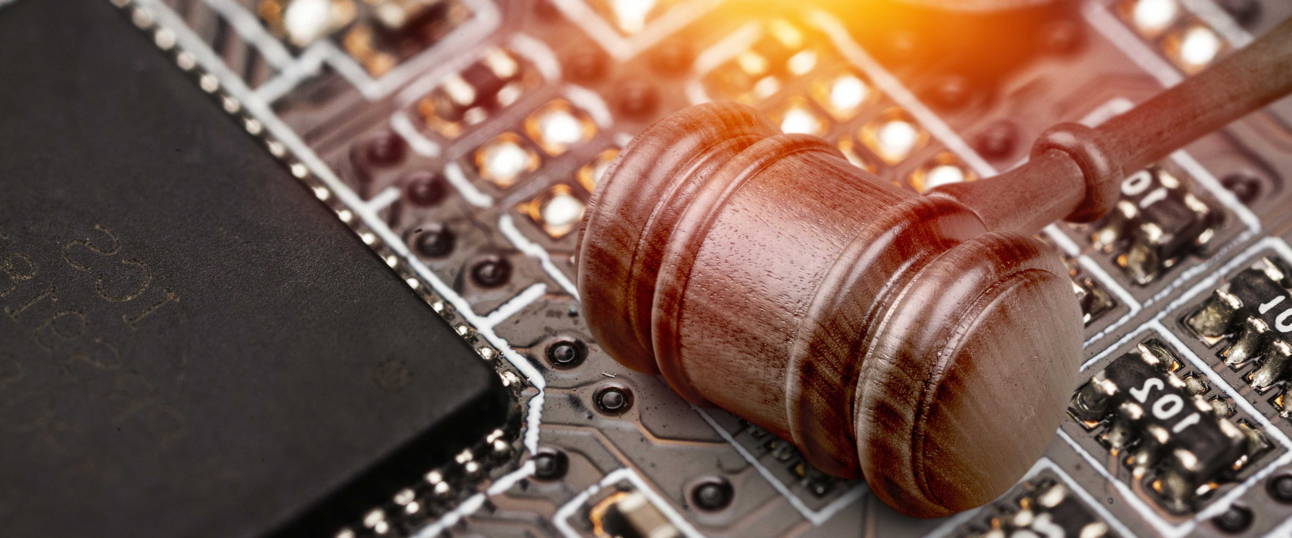 A gavel resting on a circuit board