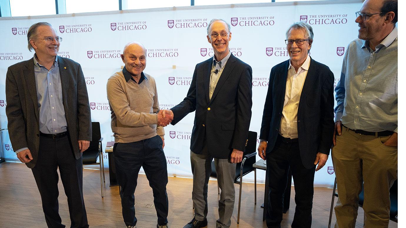 Douglas W. Diamond shakes hands with Eugene F. Fama.