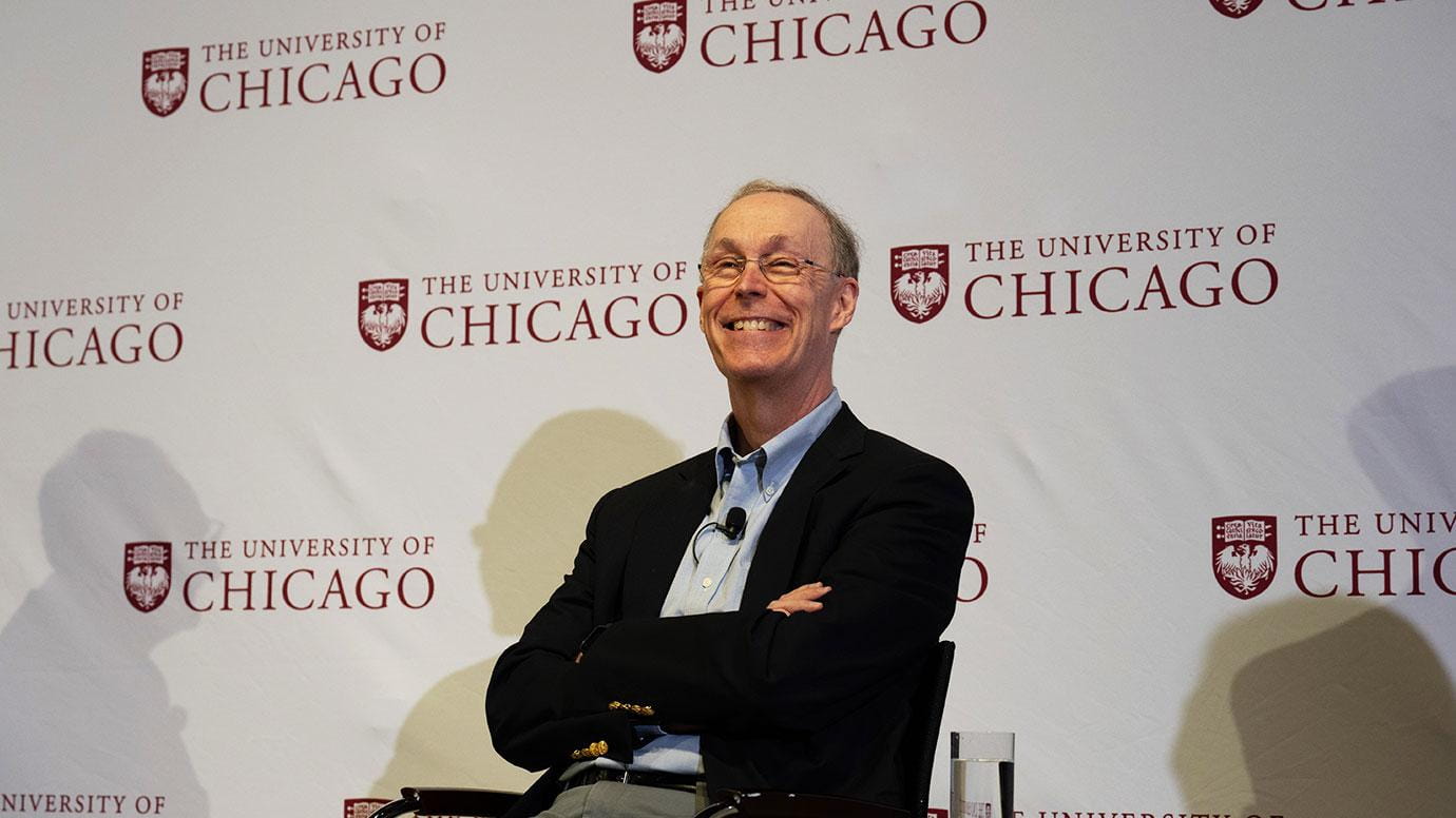 Douglas W. Diamond smiles at a news conference. 