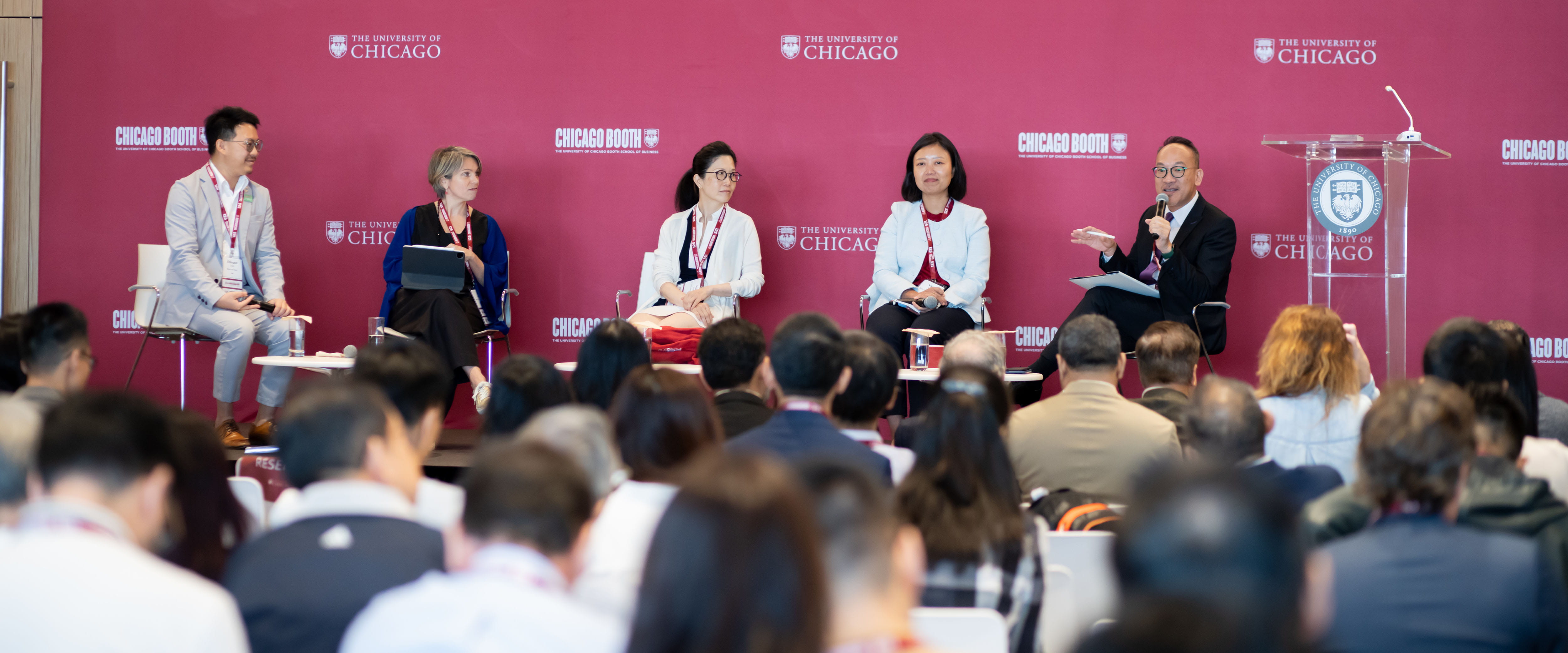 Four Booth panelists sitting on stage at the Hong Kong 5th Anniversary event