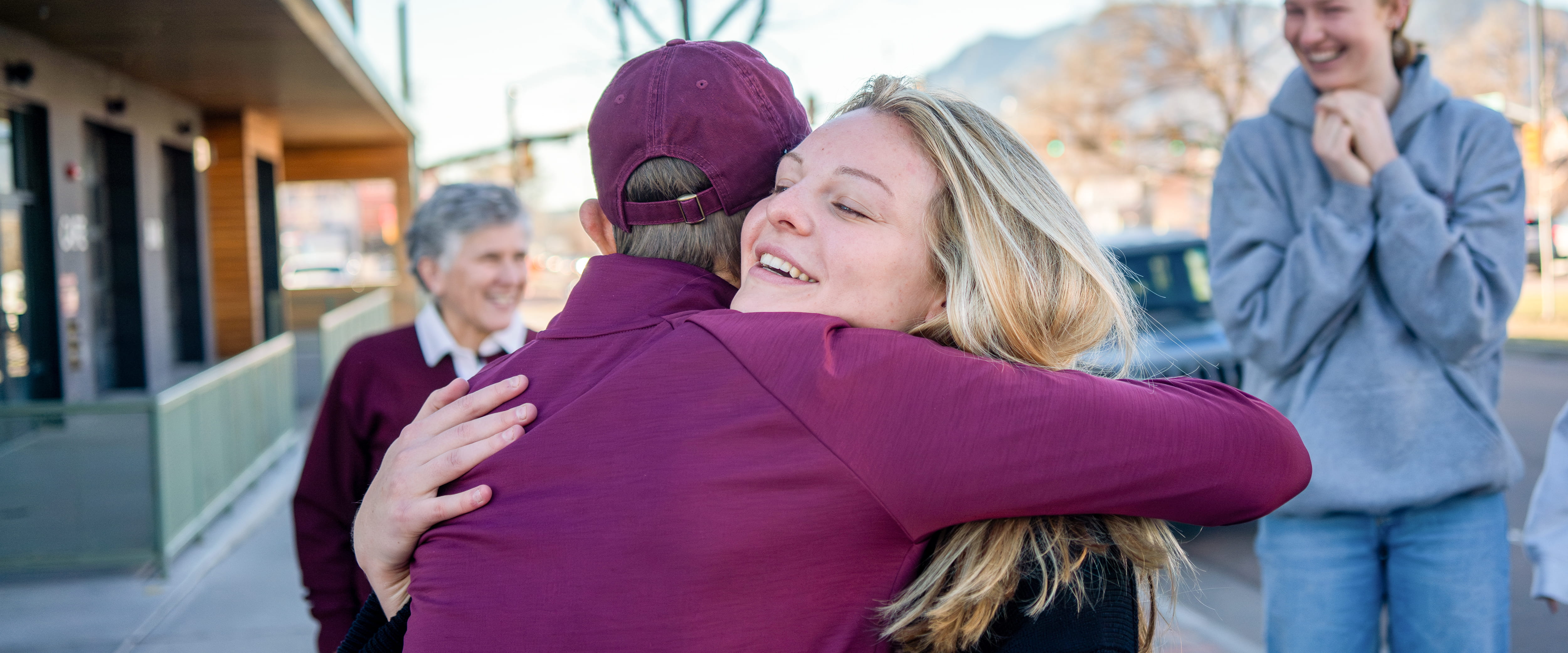 Keeley Shaye Kandziora giving a Booth admissions team member a hug