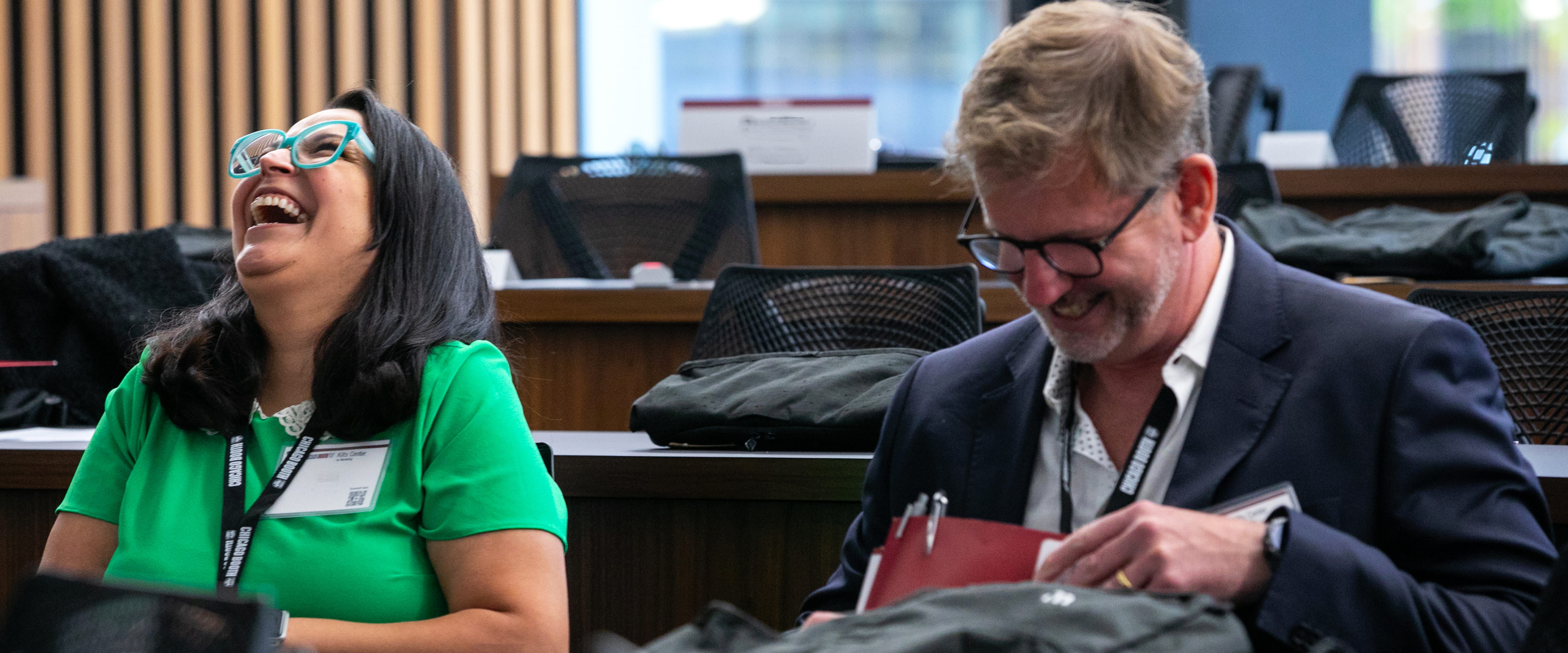 Kilts marketing summit attendees laughing in a classroom