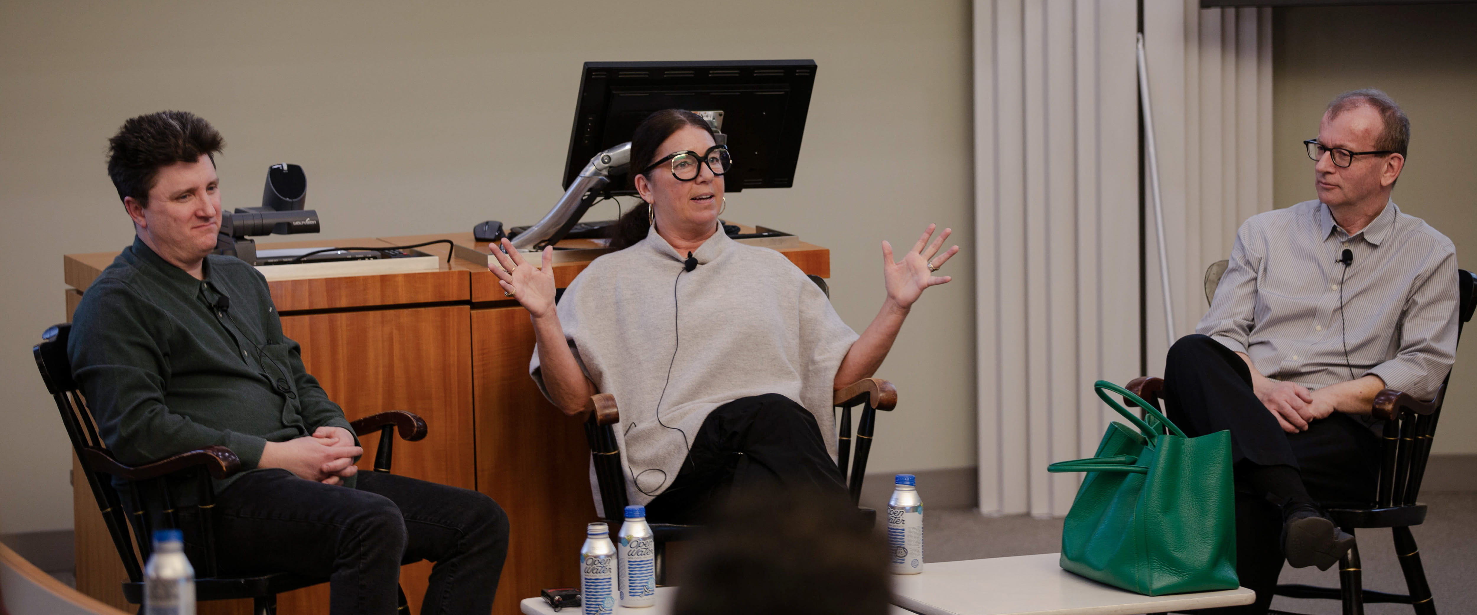 Monique Meloche, center, motions with her hands while speaking as Mike Schuh and Canice Prendergast watch.