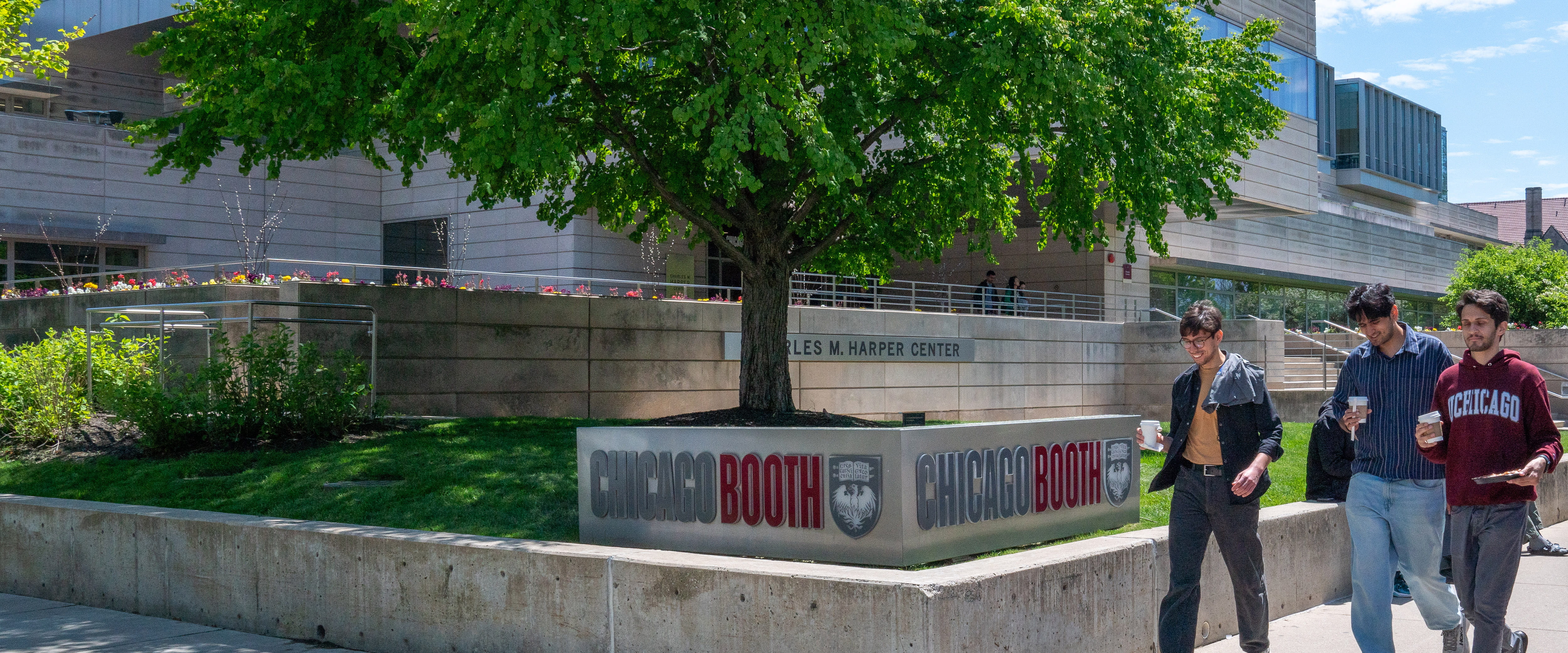 Picture of students walking outside of the Harper Center on a sunny day.