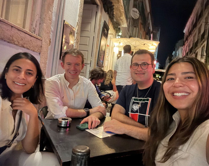 Christos Papandreou and friends in selfie while sitting outdoors at restuarant